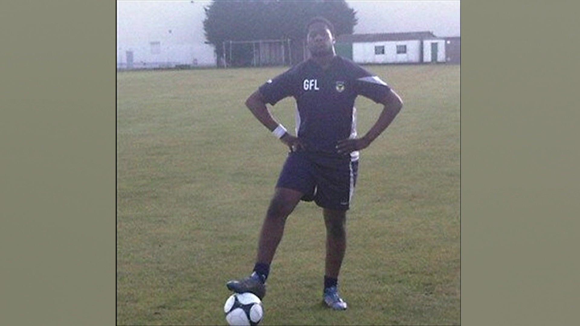 Godwin Lawson poses with a football 