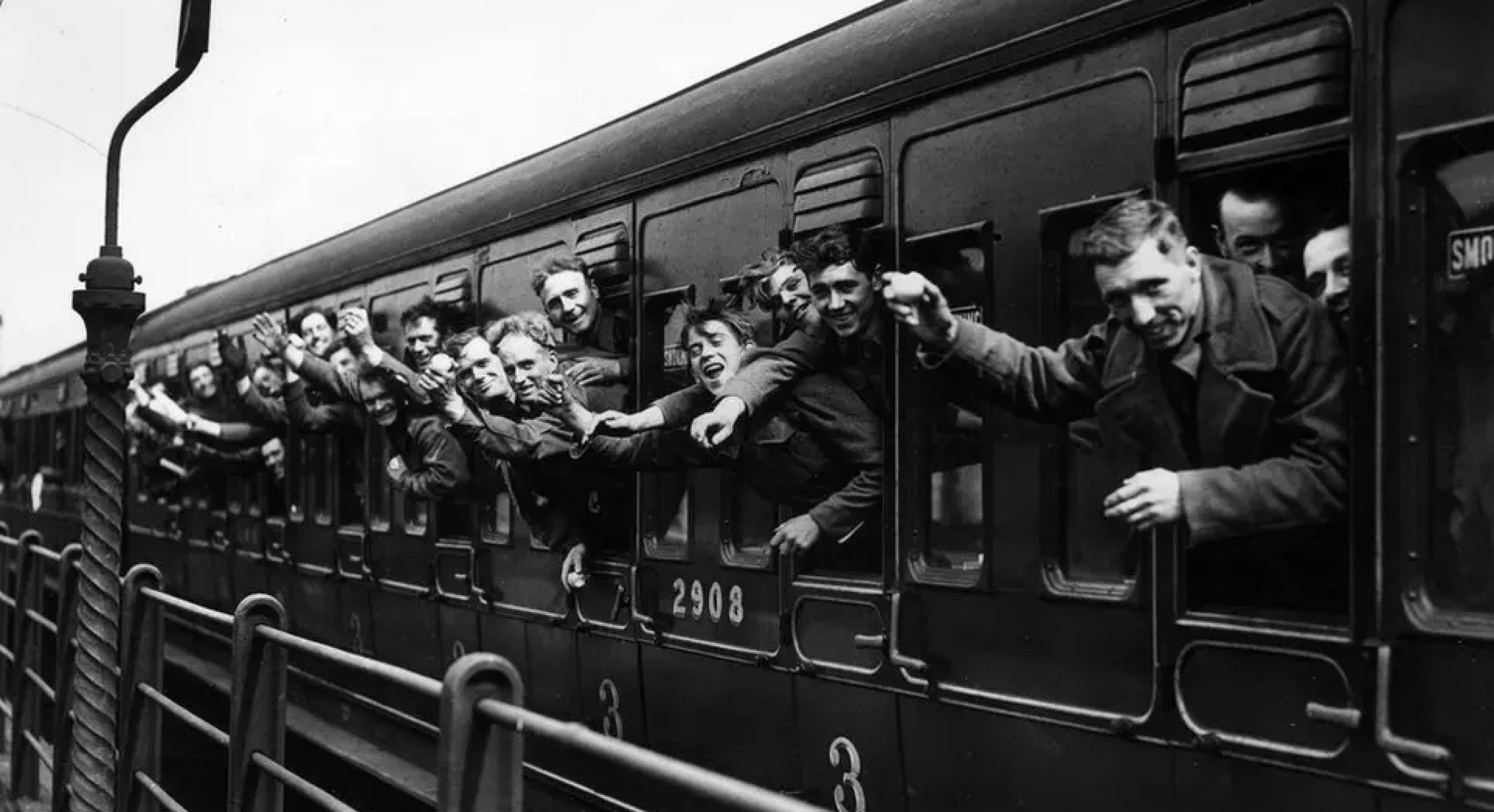 Soldiers waving out of train windows