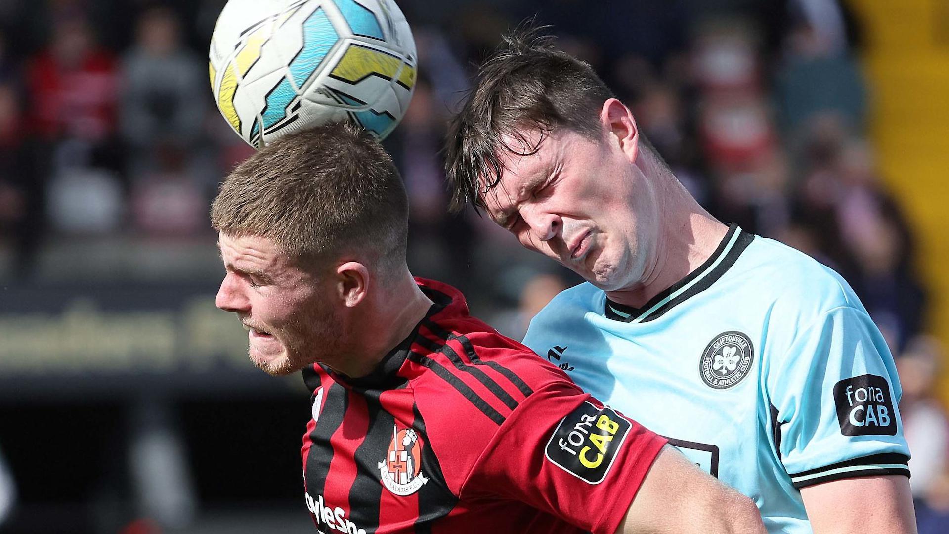 Crusaders scorer Kieran Offord beats Cliftonville's Shaun Leppard to the high ball