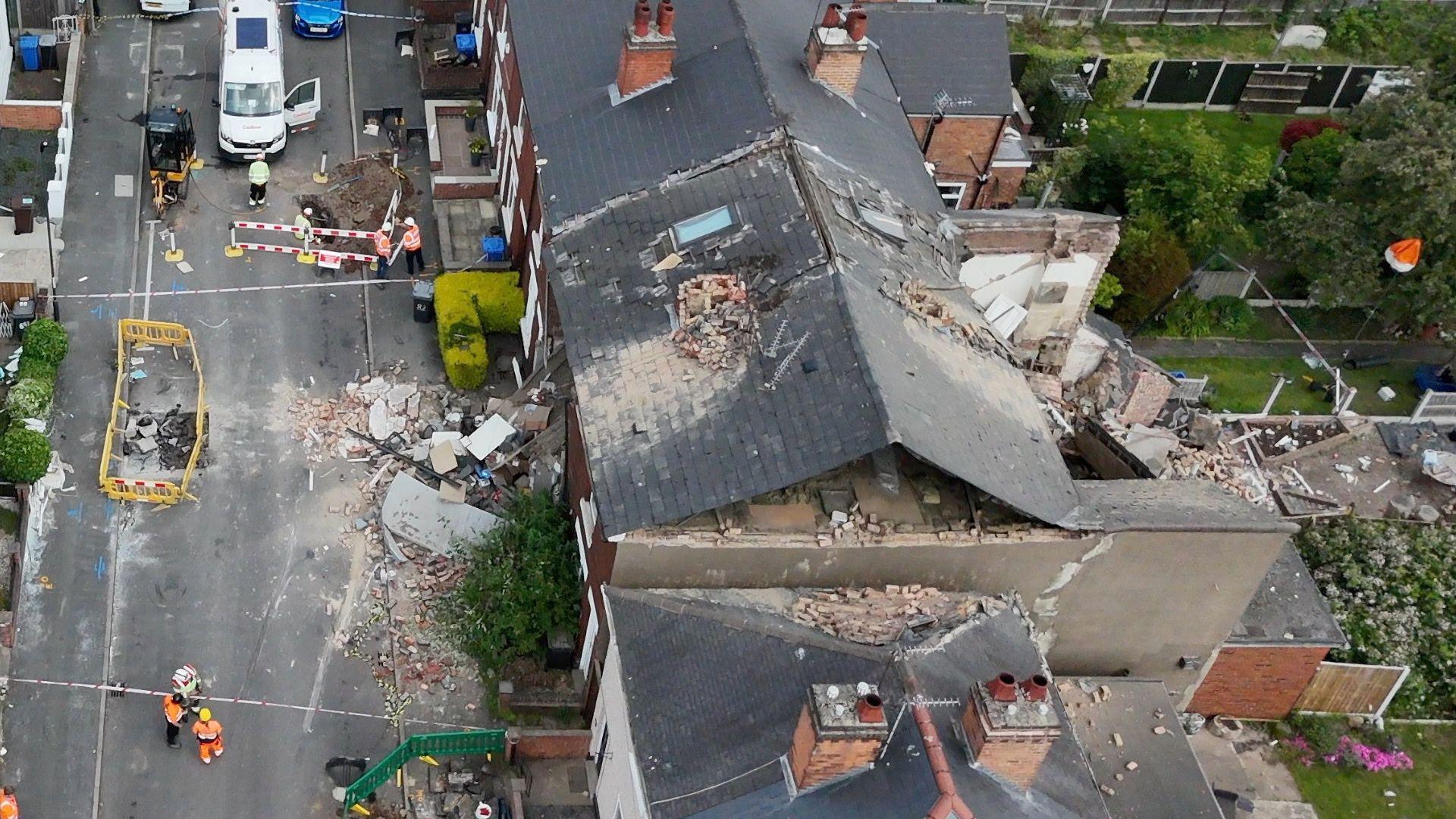 An aerial view of damage to a terrace row of houses