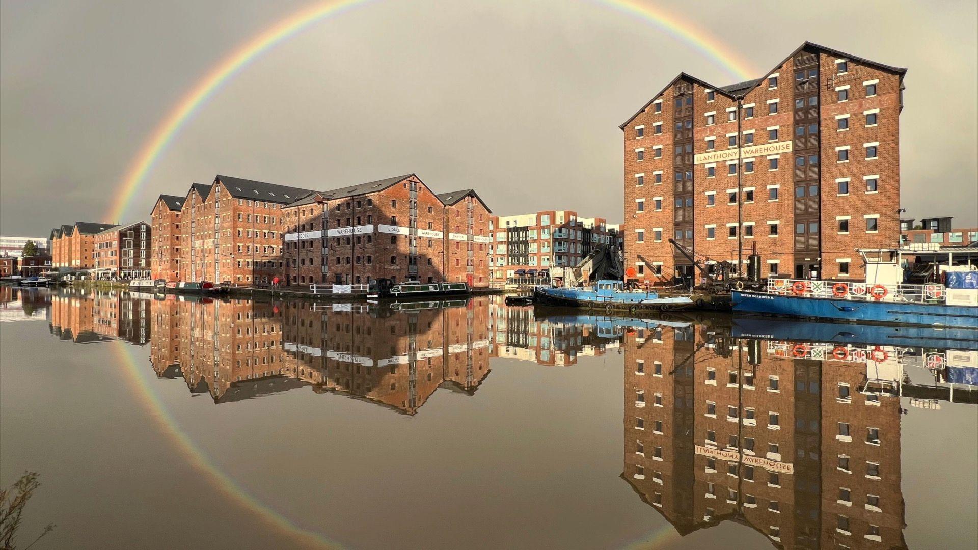 Gloucester Docks with a perfect reflection of a rainbow over the warehouses.