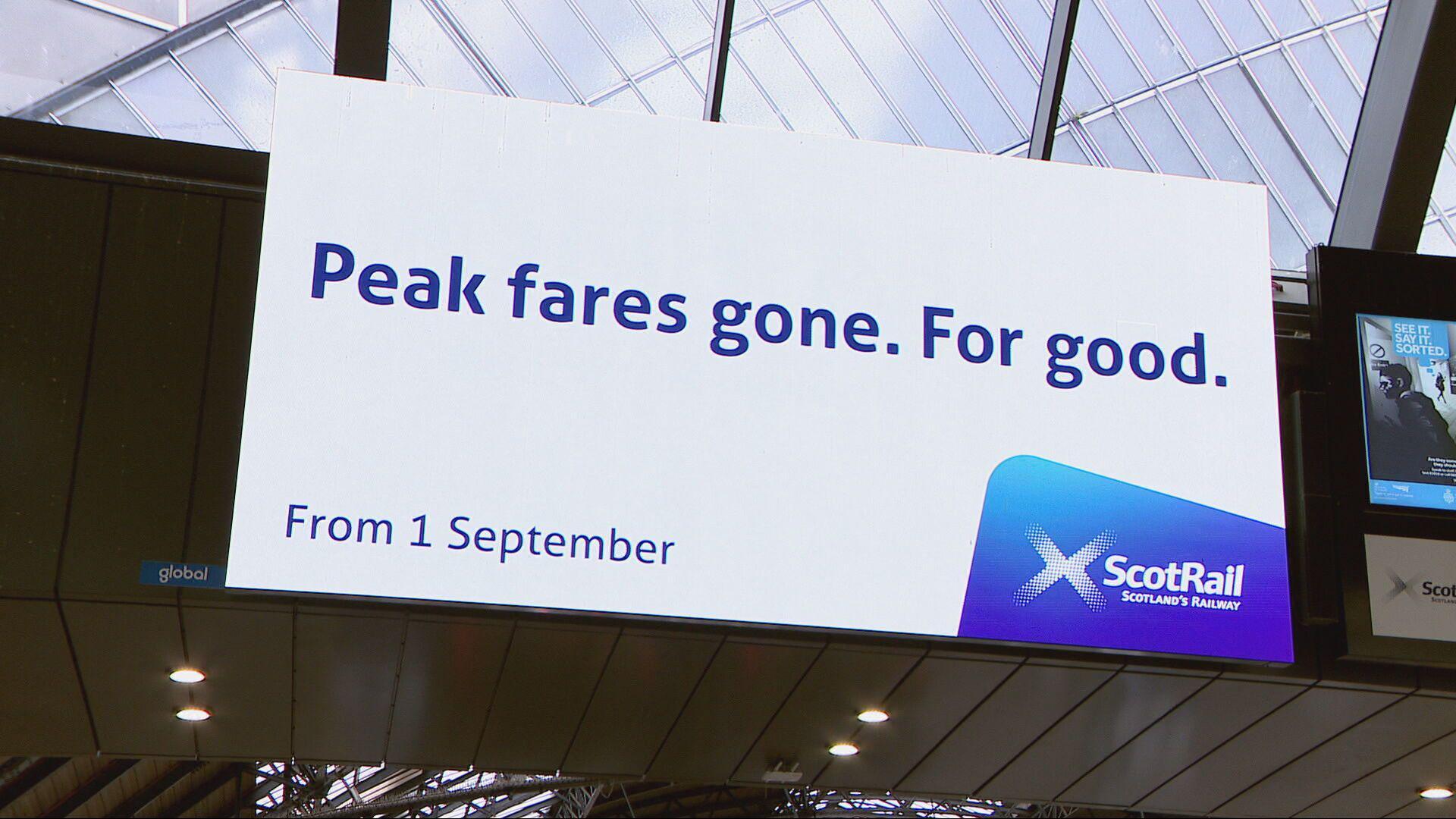 A digital billboard at Queen Street Station in Glasgow says "Peak fares. Gone for good."