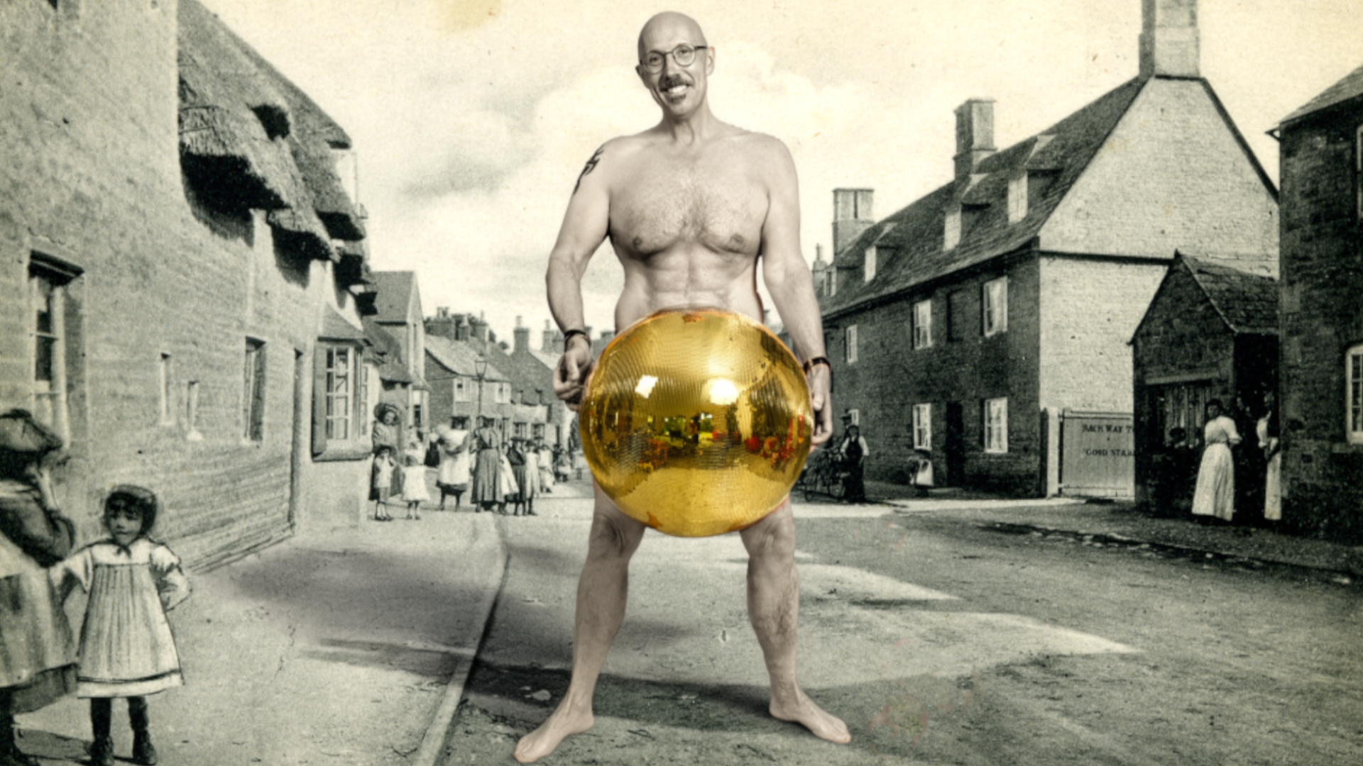 Chris Wickes is naked but holding a gold bauble at this waist. He is pictured on a backdrop of a black and white image of a Victorian lane, with families crowded around.