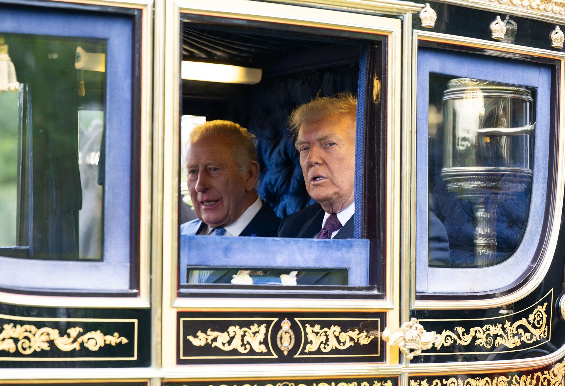  King Charles III and U.S. President Donald Trump in a carriage during the carriage procession during the State visit by the President of the United States of America at Windsor Castle on September 17, 2025 in Windsor, England. 