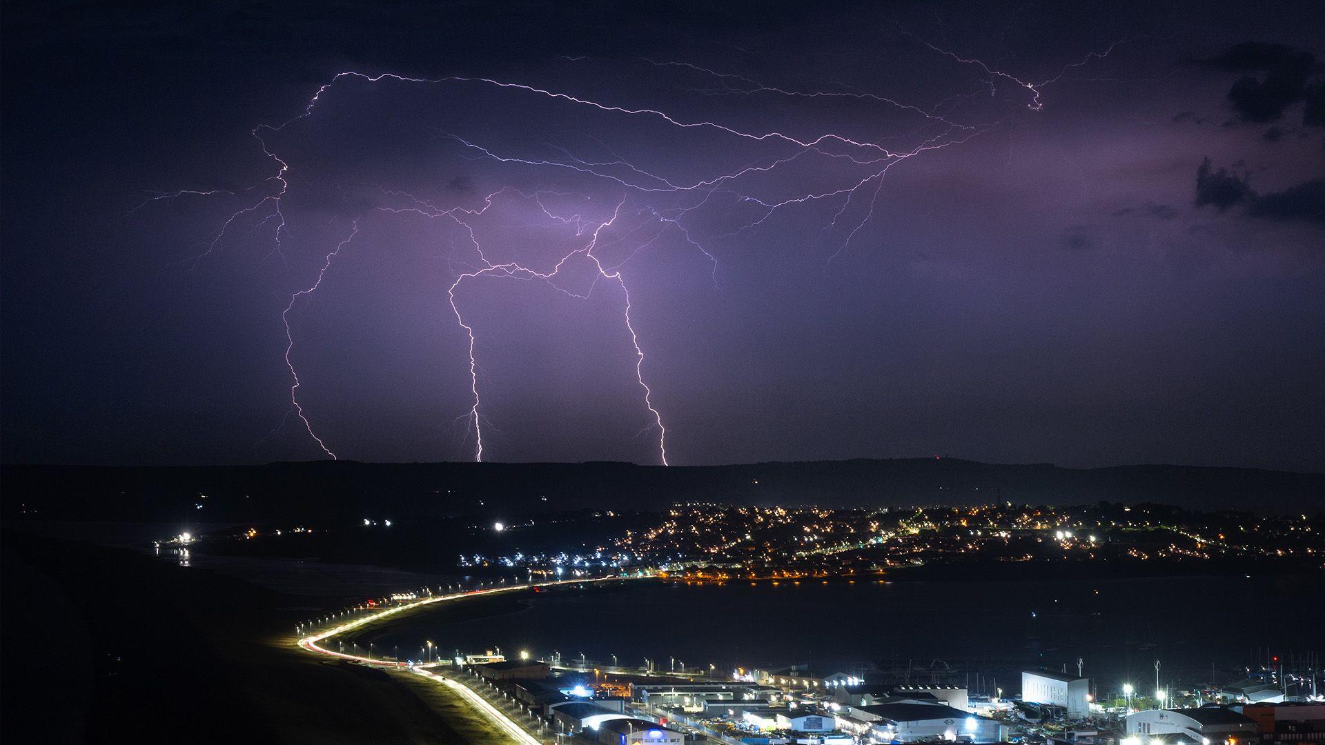 Lightning strikes are seen during a storm over Weymouth.