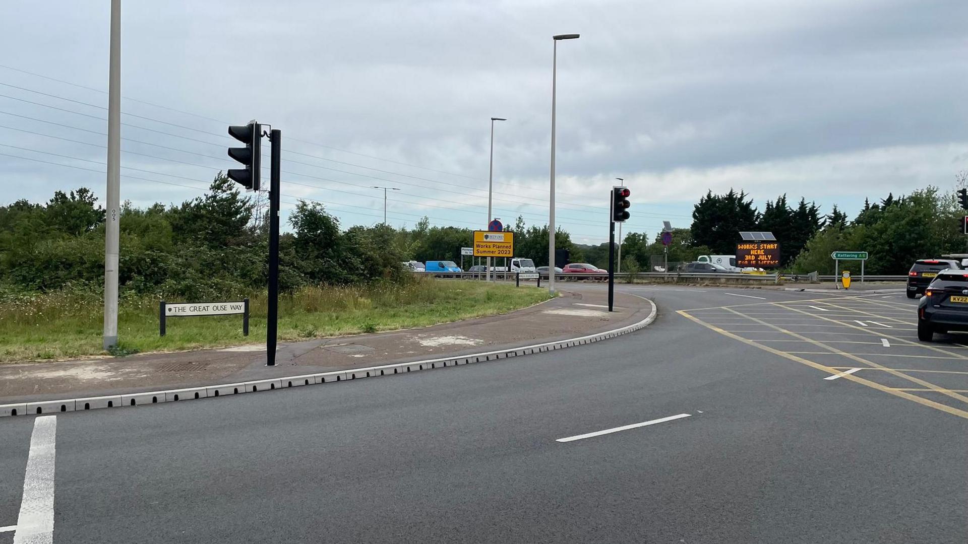 The Paula Radcliffe Way, in Bedford, now open, showing a roundabout and cars on it