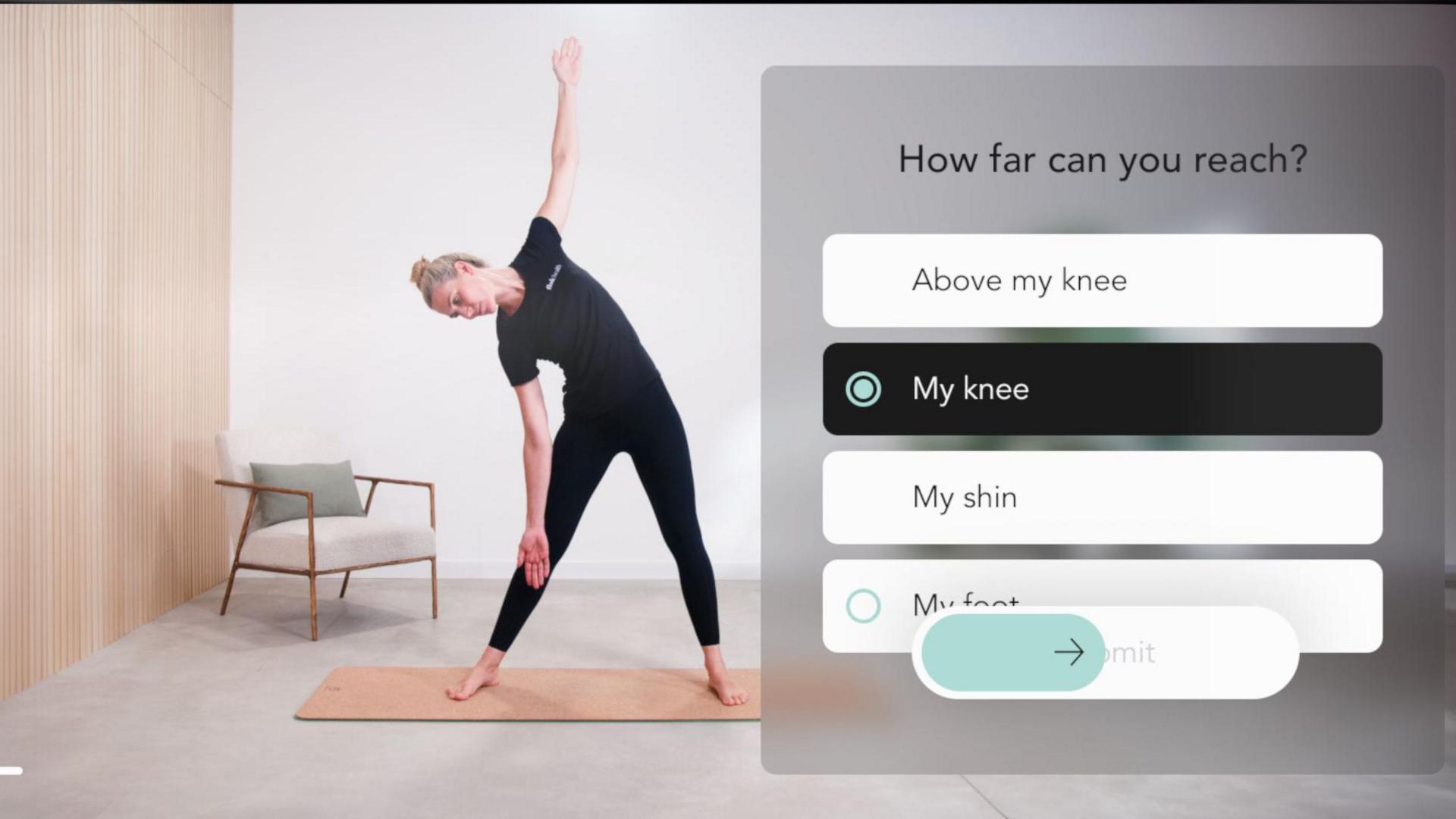 A screen grab from the app. On the right is the question "how far can you reach?" with a series of multiple choice answers below, such as 'my knee' for the patient to select. On the right, a physiotherapist, dressed in black leggings and T-shirt is showing a stretching exercise. She has her feet apart and leans from her waist to her right hand side. Her right arm is stretching down towards her shin and her left arm is in the air.