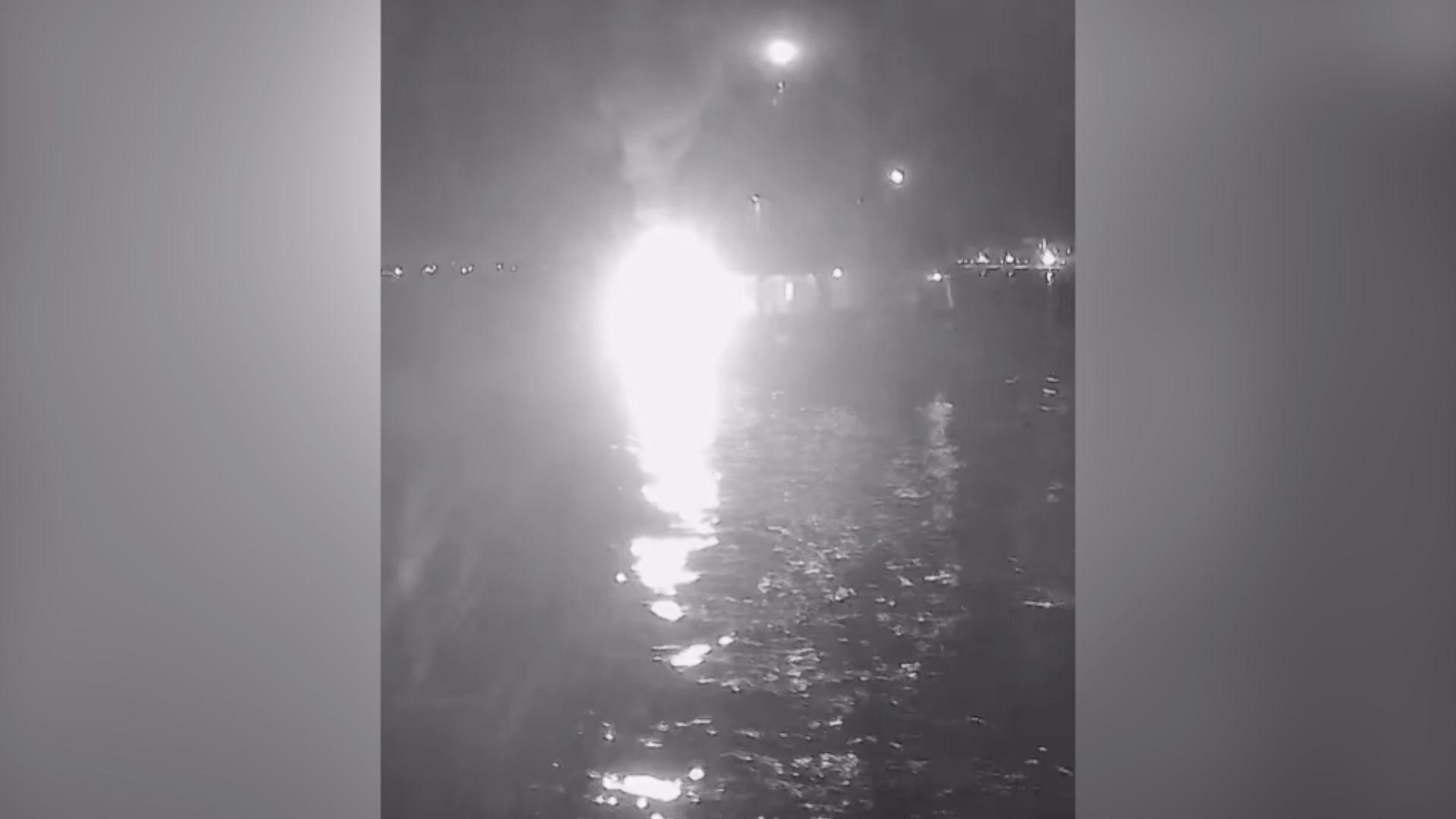 A bright white light which looks like an explosion is seen in a video purporting to show a boat being hit by a flaming object 