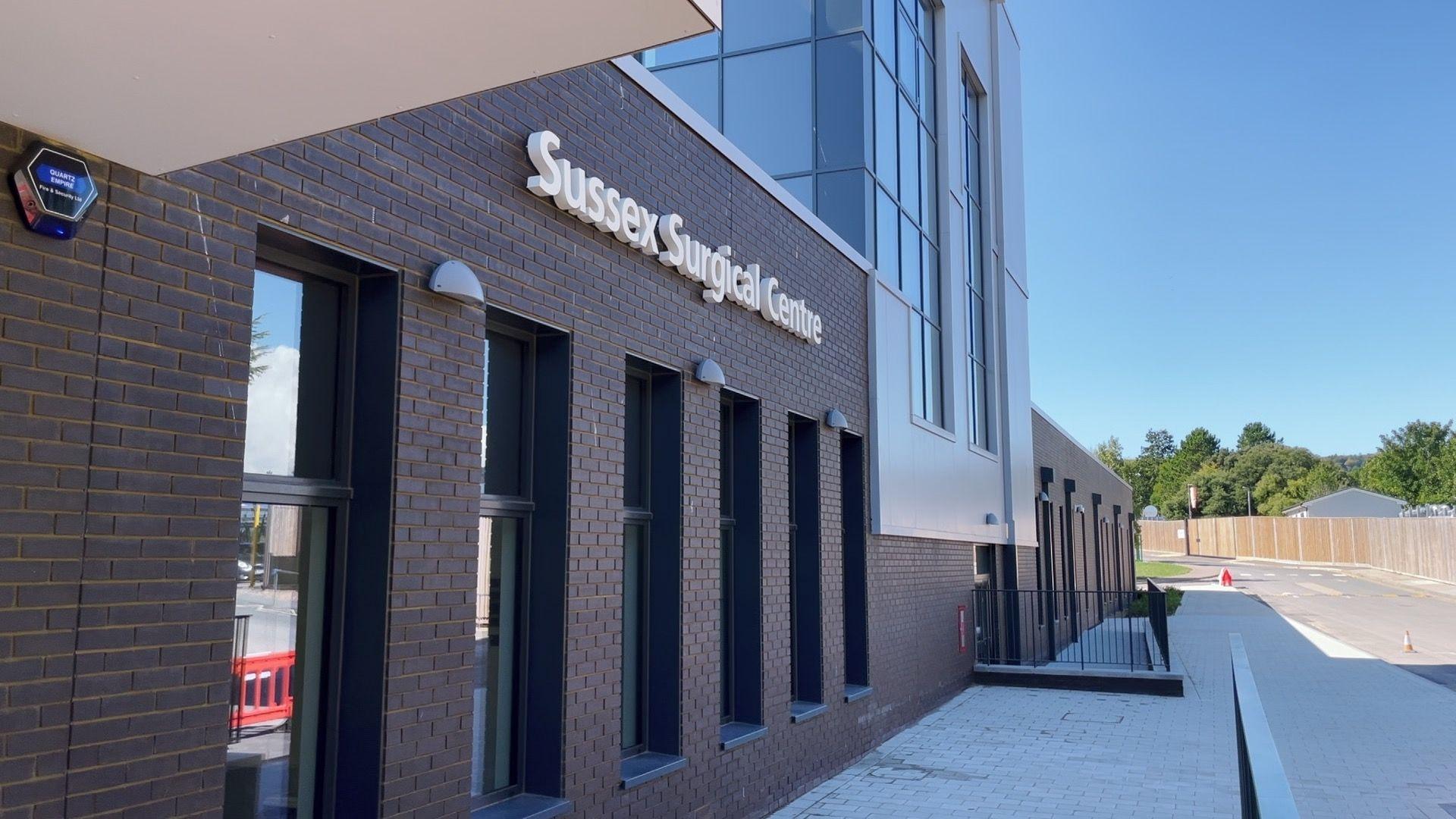 A modern building with a sign reading "Sussex Surgical Hub"