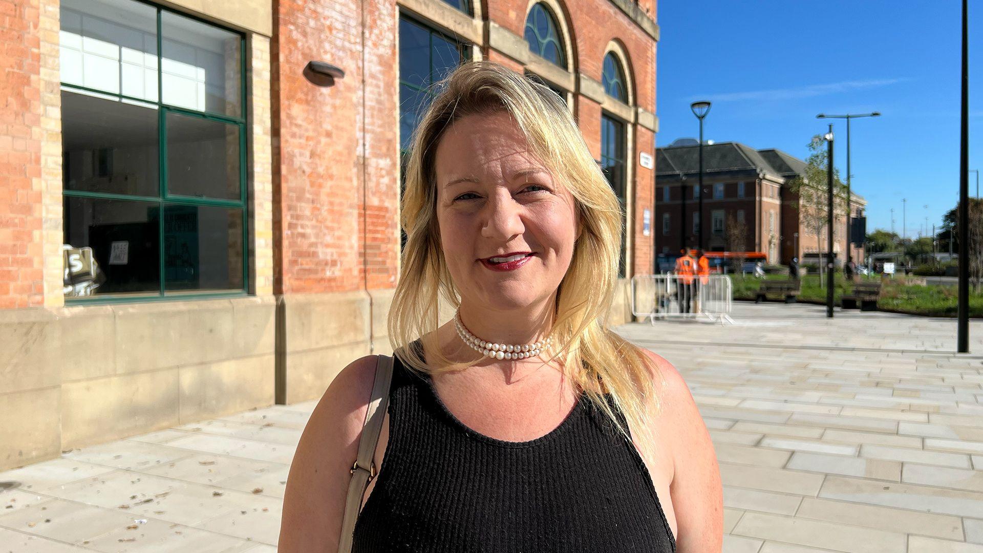 Katie Gibson, owner of Derby Pyclet Parlour, standing outside the Market Hall in Derby.