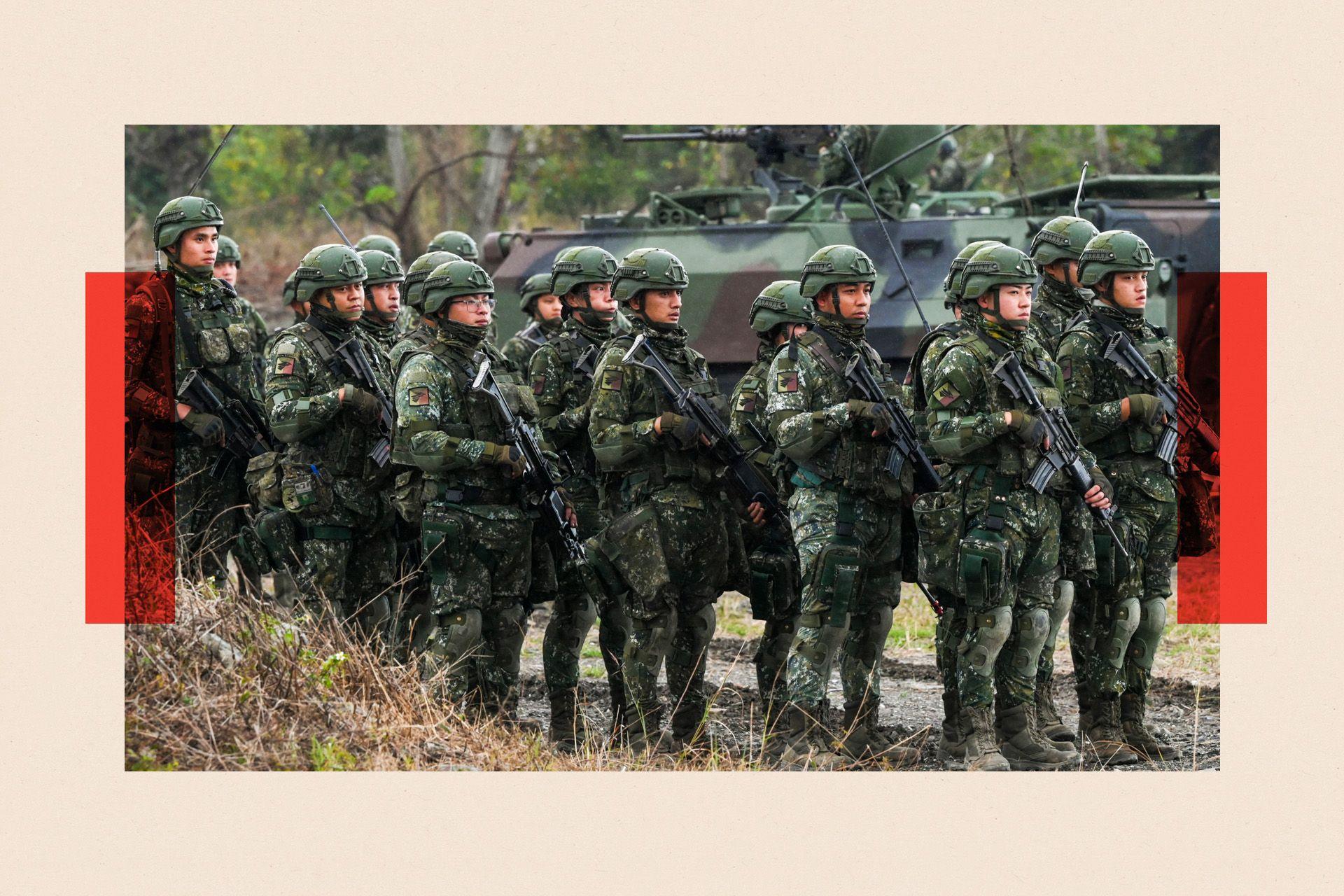 Army soldiers holding guns take part in an exercise in Taitung 