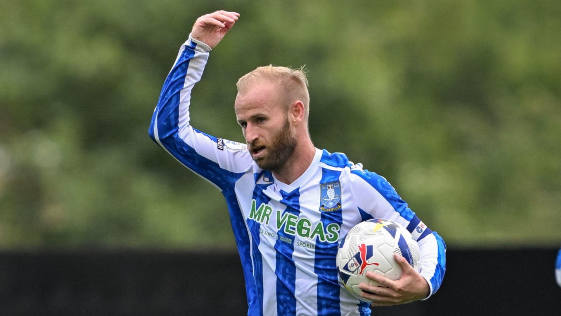 Sheffield Wednesday's Barry Bannan raises his arm in the air with a football tucked under his arm