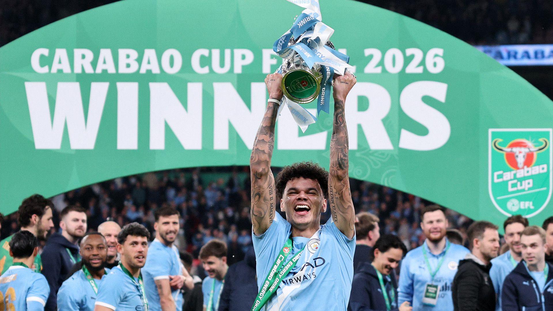 Nico O'Reilly lifts the Carabao Cup with a big smile on his face.