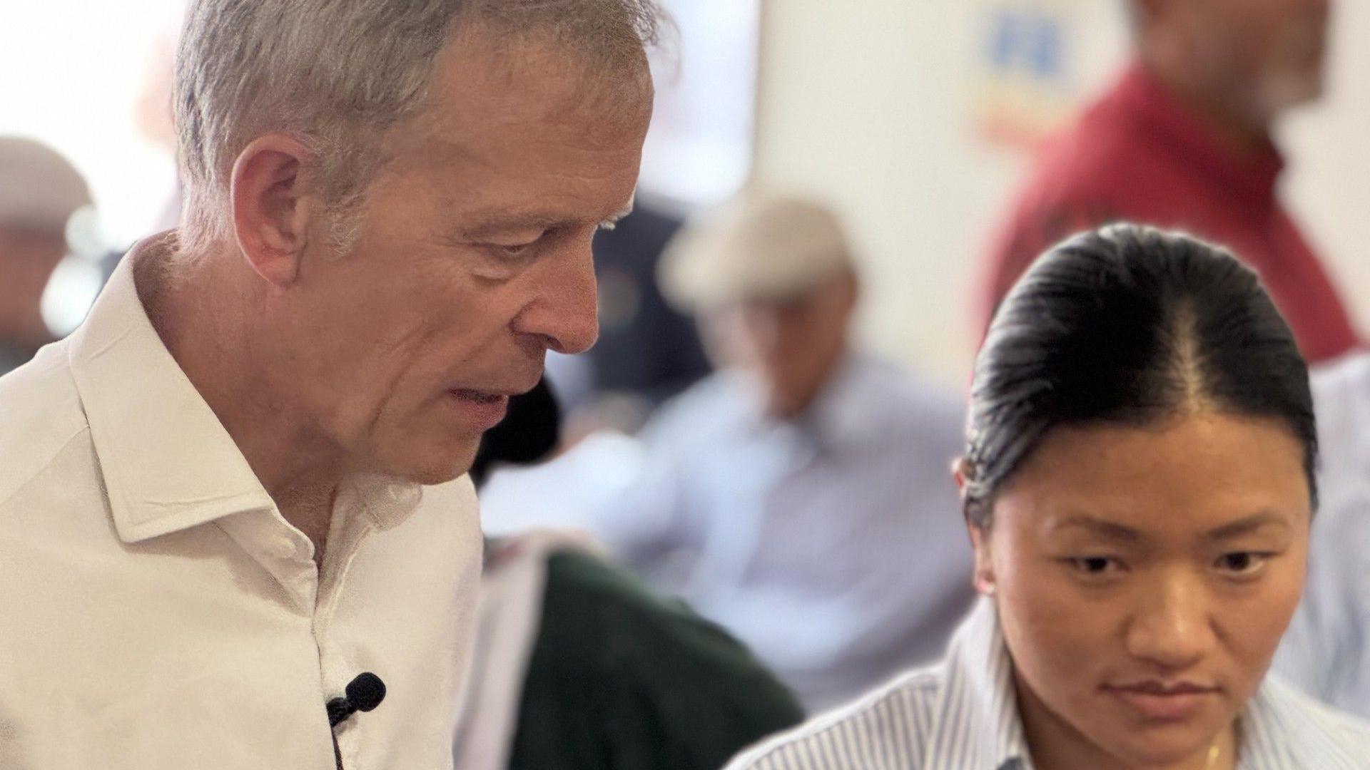 Matt Rodda MP is standing alongside Pratikshya Gurung, talking and listening to a group of Gurkha veterans at their community centre in Reading. Deep in conversation.