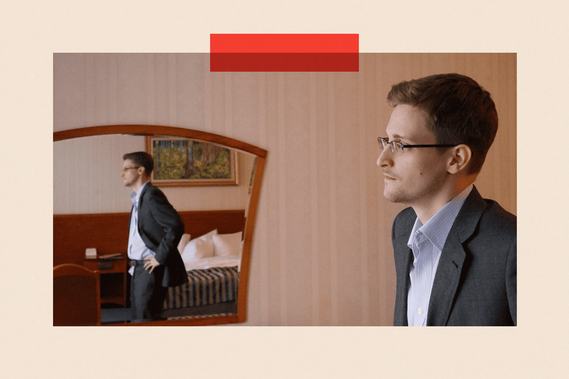 Edward Snowden stands in a hotel room