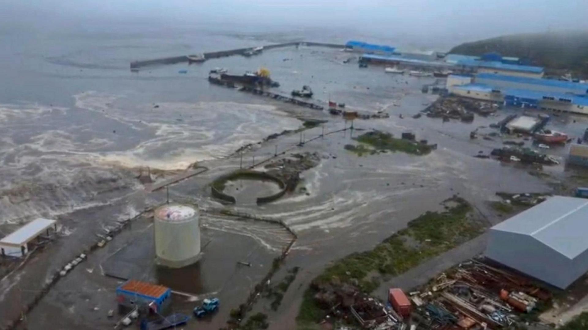 Aerial shot showing brown ocean water flooding into industrial land