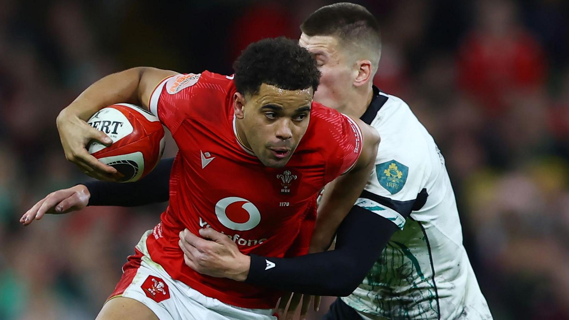 Wales centre Ben Thomas being tackled against Ireland