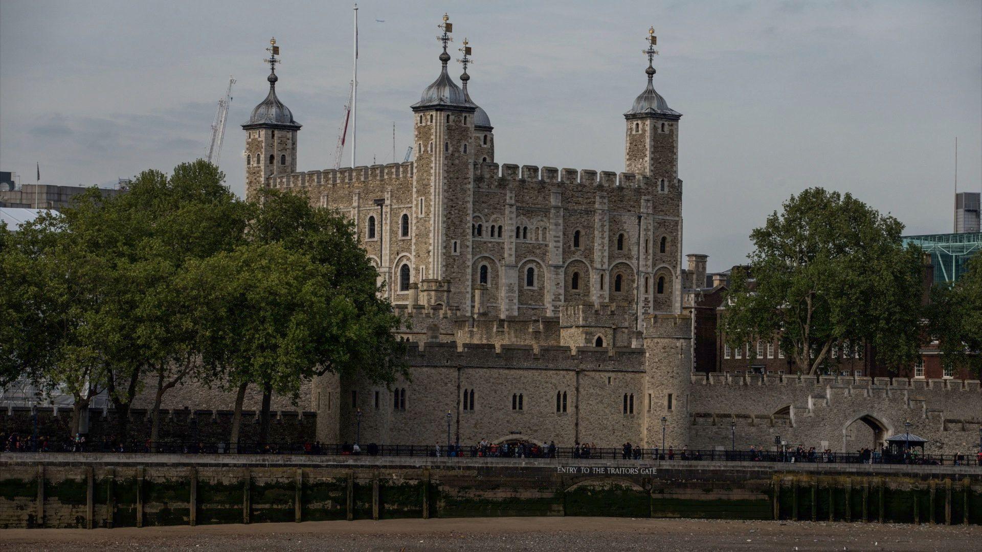 A view of the historic castle, which is located on the bank of the River Thames in central London, from a boat.