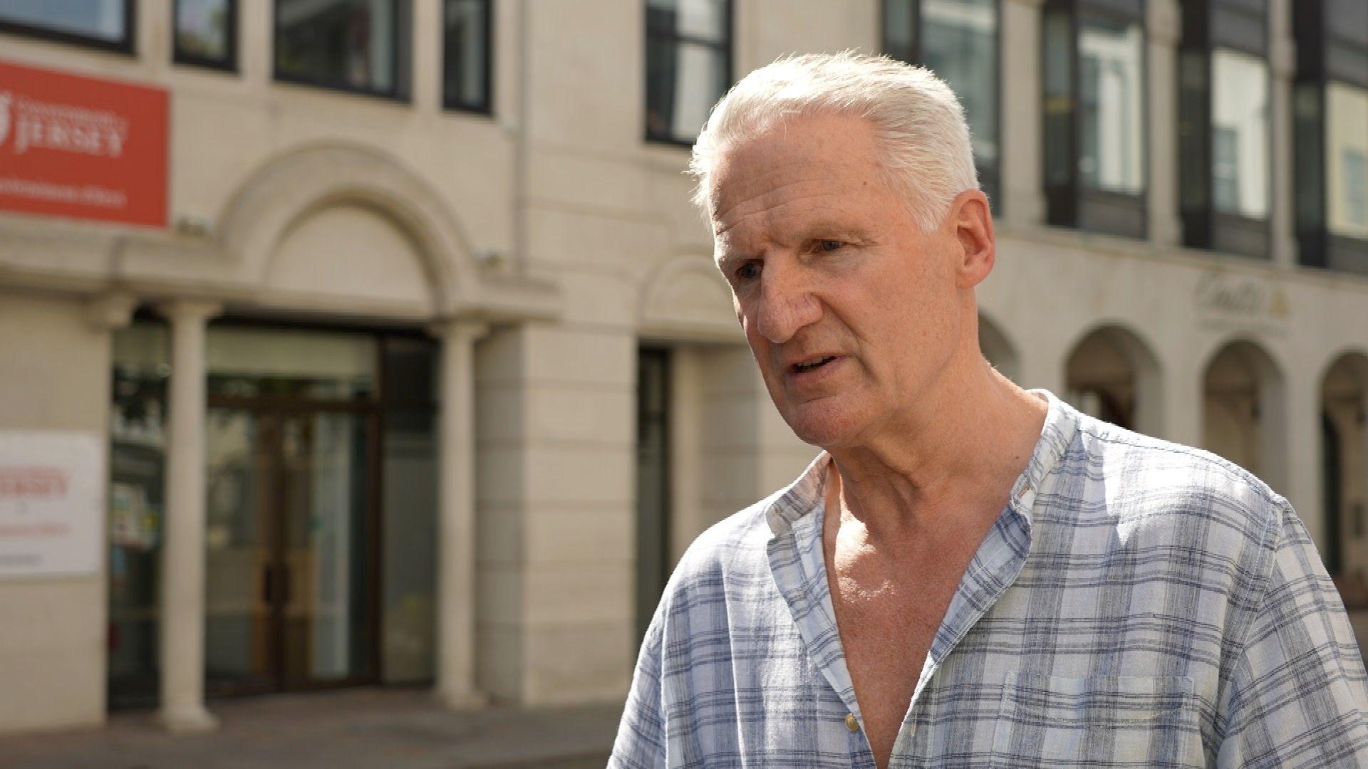 Deputy Tom Binet, the health minister outside the government office 