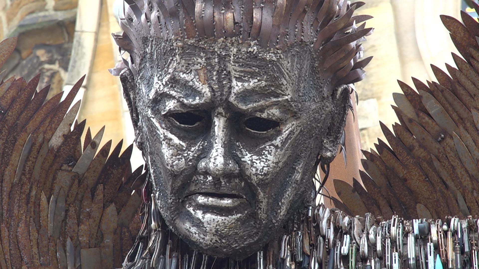 A sculpture of a man made from knives