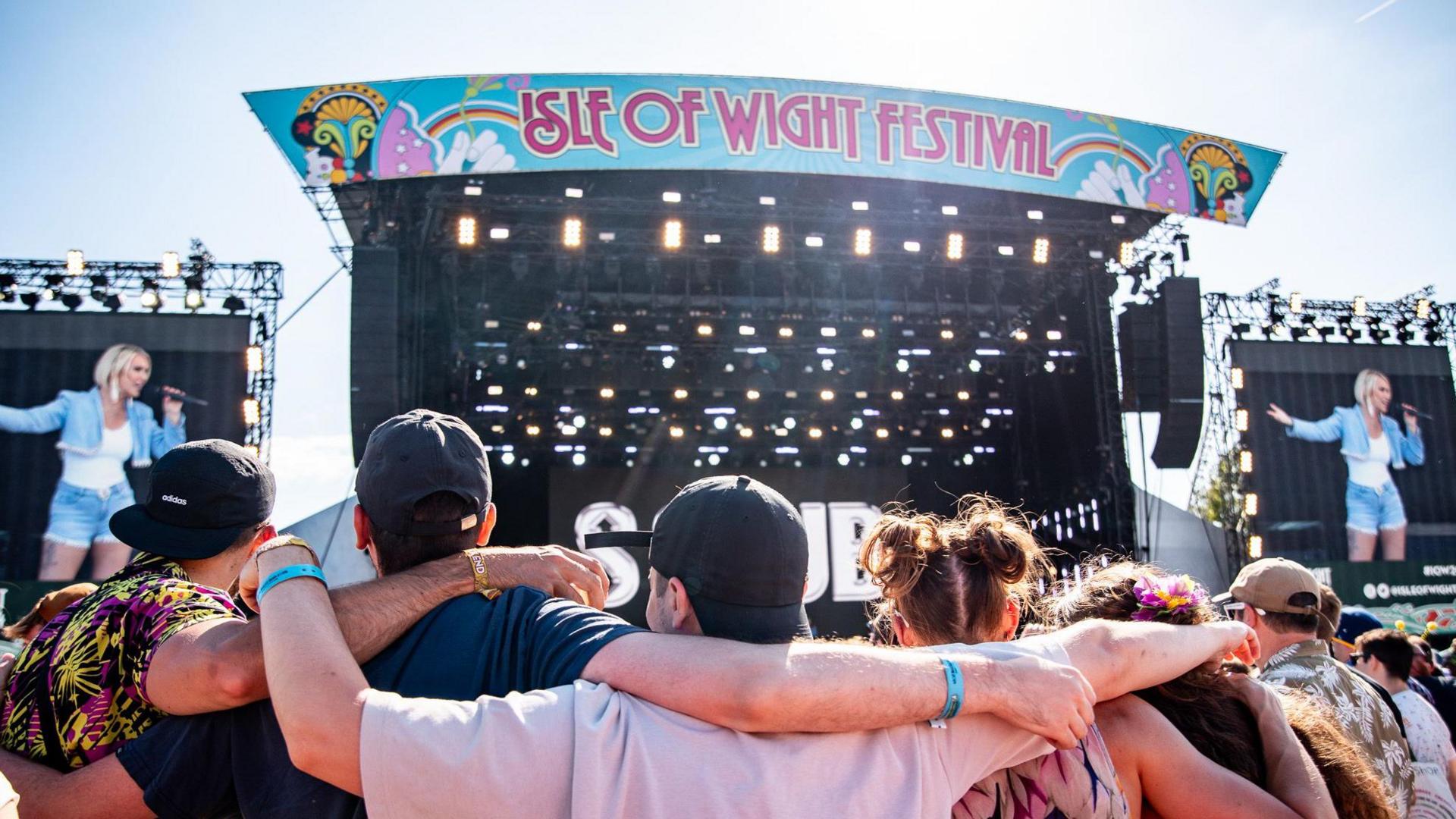 People in arms in front of S Club on the main stage