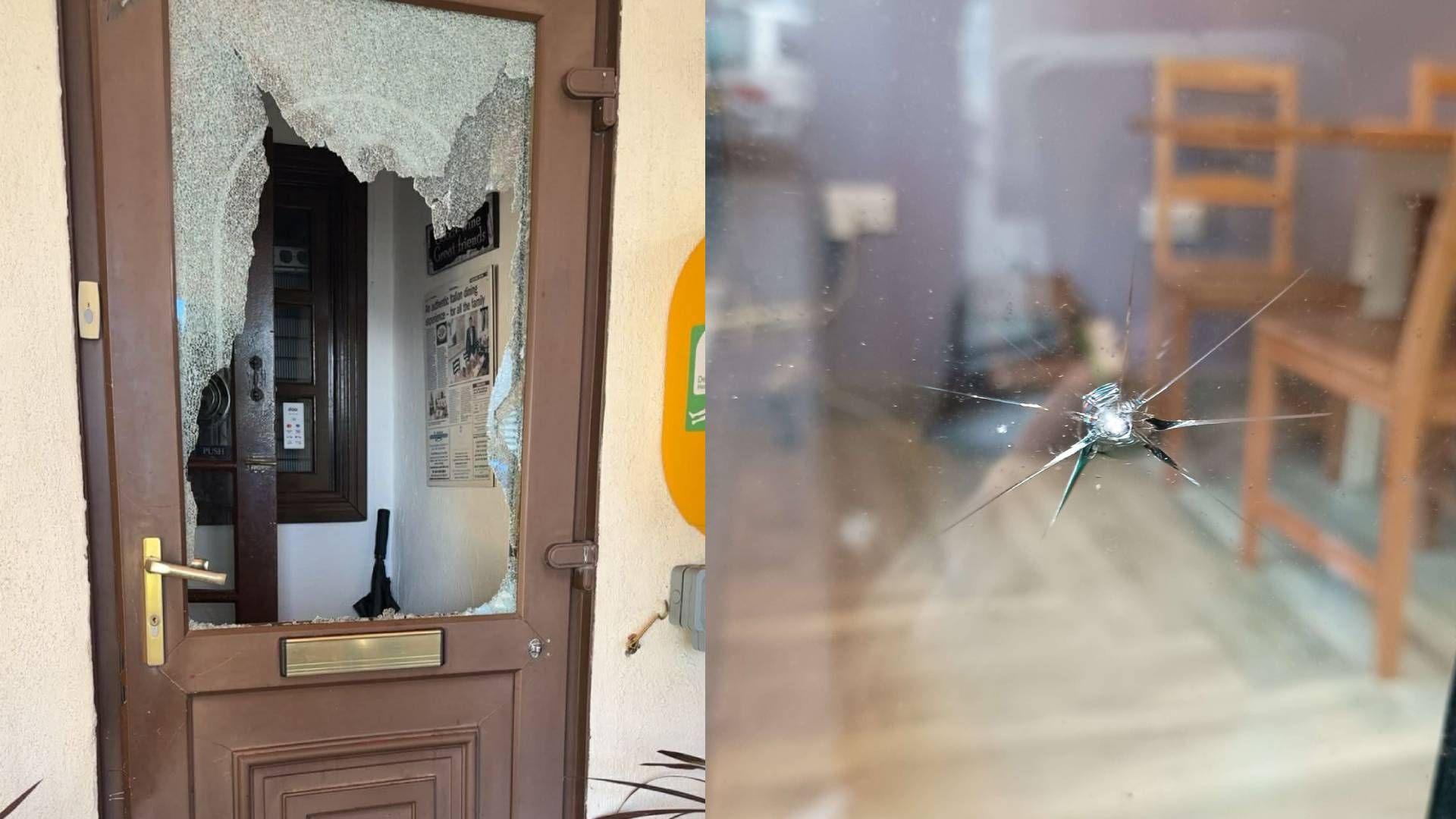 Photograph of Stefanos front door (left) which is brown with a gold handle and it has a window smashed through entirely. The photograph on the right shows a glass window which has a large crack in it. Through the window you can see a wooden table and chairs. 