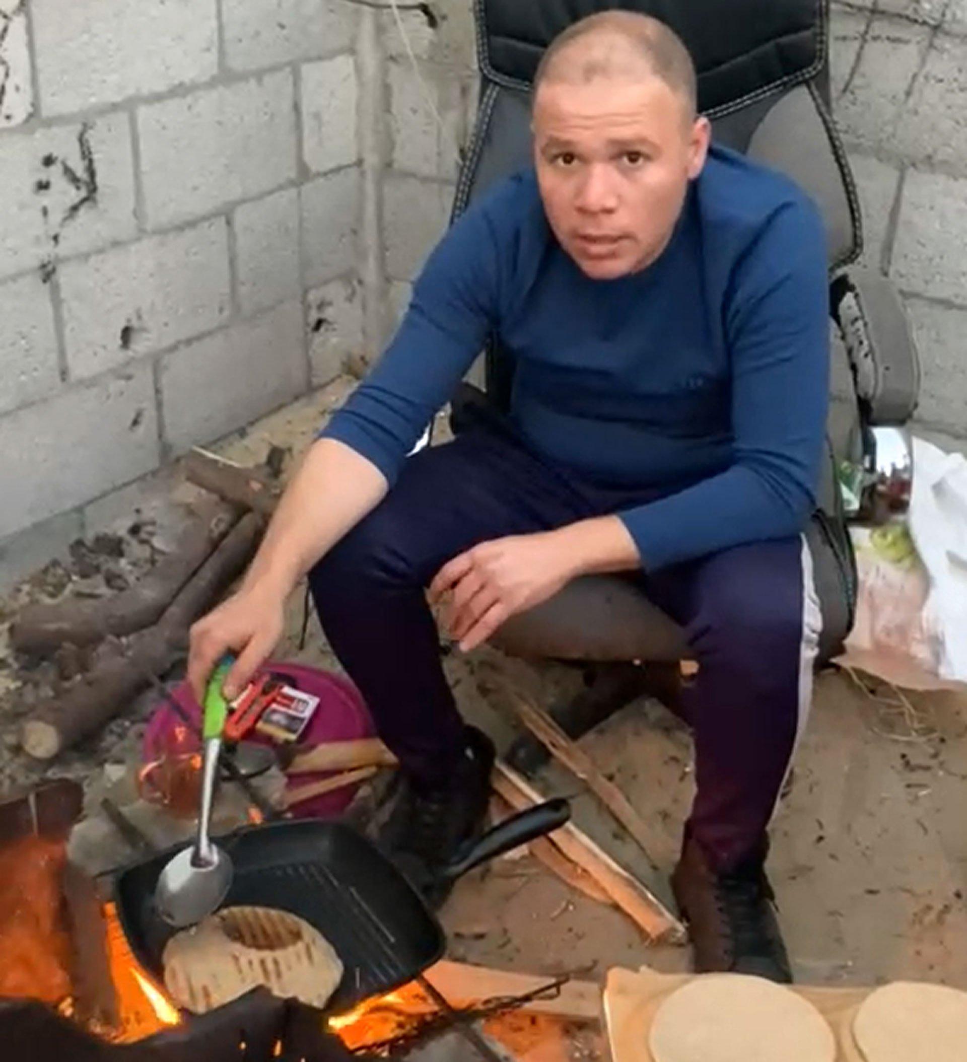 Jehad cooks over an open fire for his family in Rafah