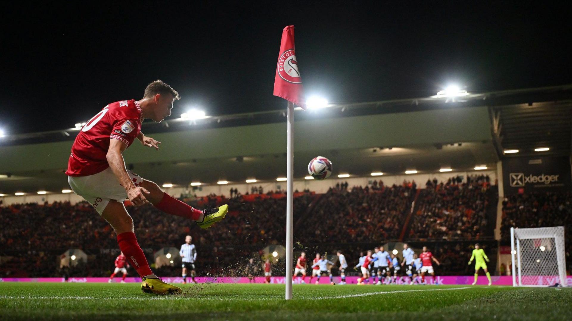 Scott Twine of Bristol City sends in a corner during the match against Sheffield Wednesday at Ashton Gate. In the distance players from both sides can be seen getting ready to contest the ball in the penalty area