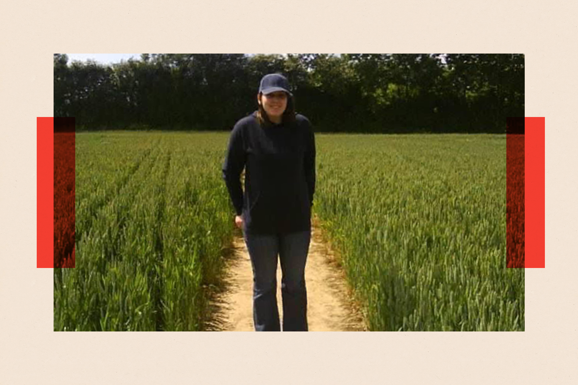 Rachel smiles while being pictured outdoors on a path in a field. This is a treated image with partially red borders.