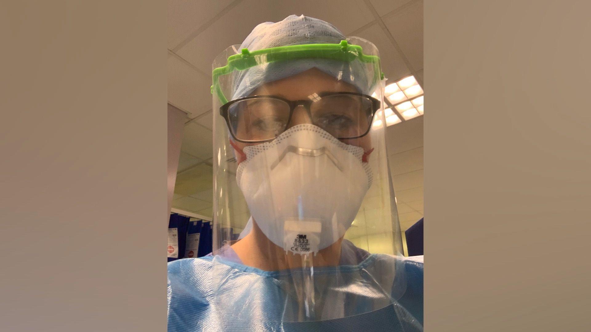 Senior Sister Lauren Jakes in full PPE during the second wave of the covid pandemic in 2021. She is wearing a gown, hair net, FFP3 mask, and a full face visor. 