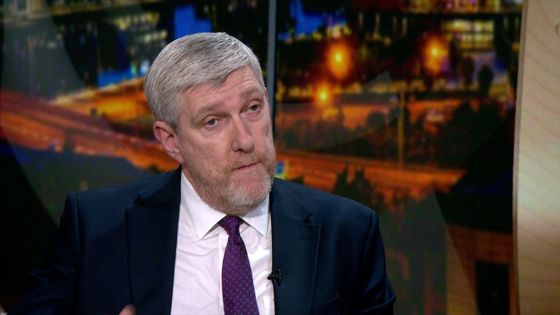 John O'Dowd on the View in a navy blazer, white shirt and purple tie