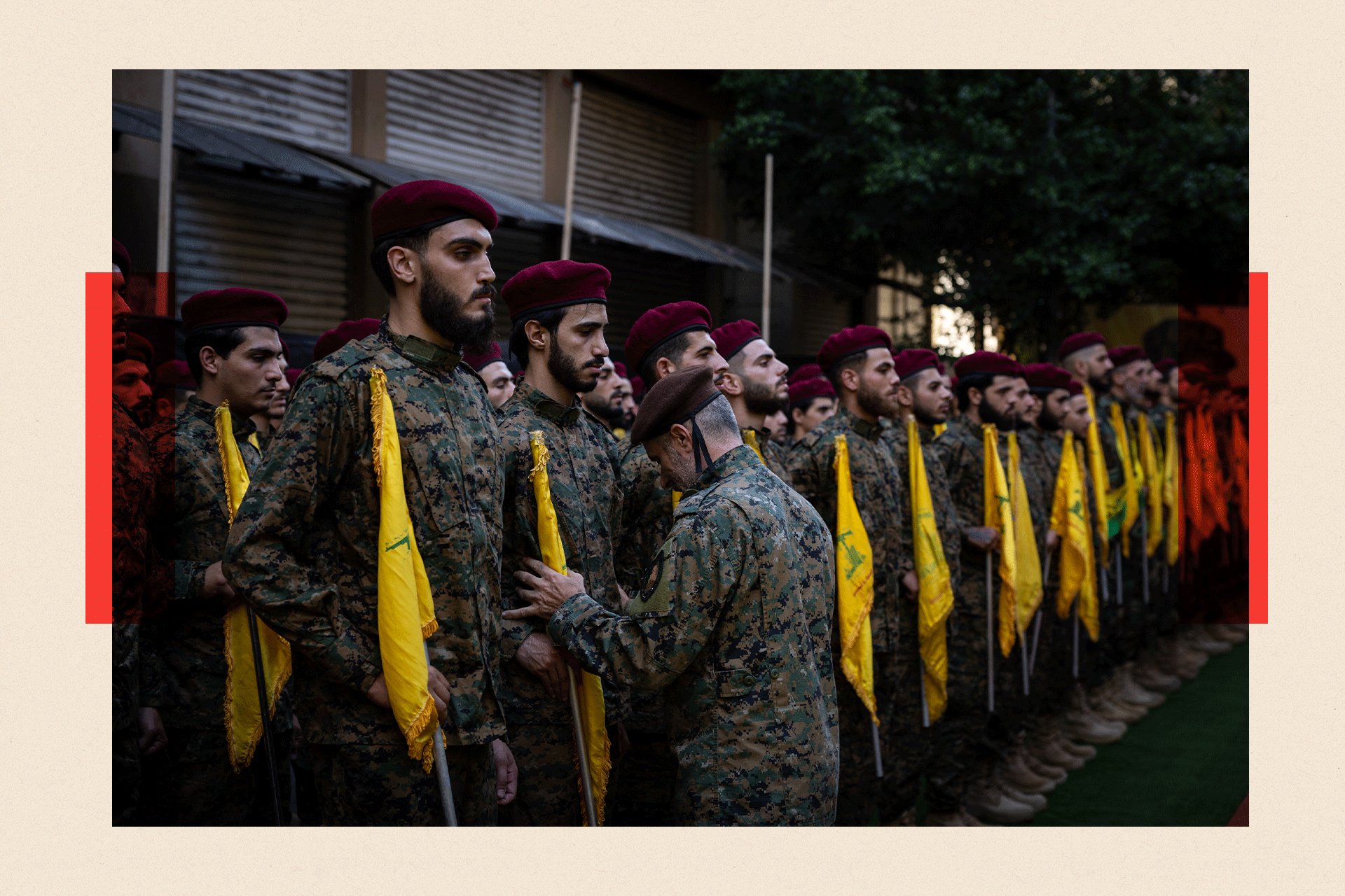 Hezbollah fighters line up to attention at the funeral of two Hezbollah commanders