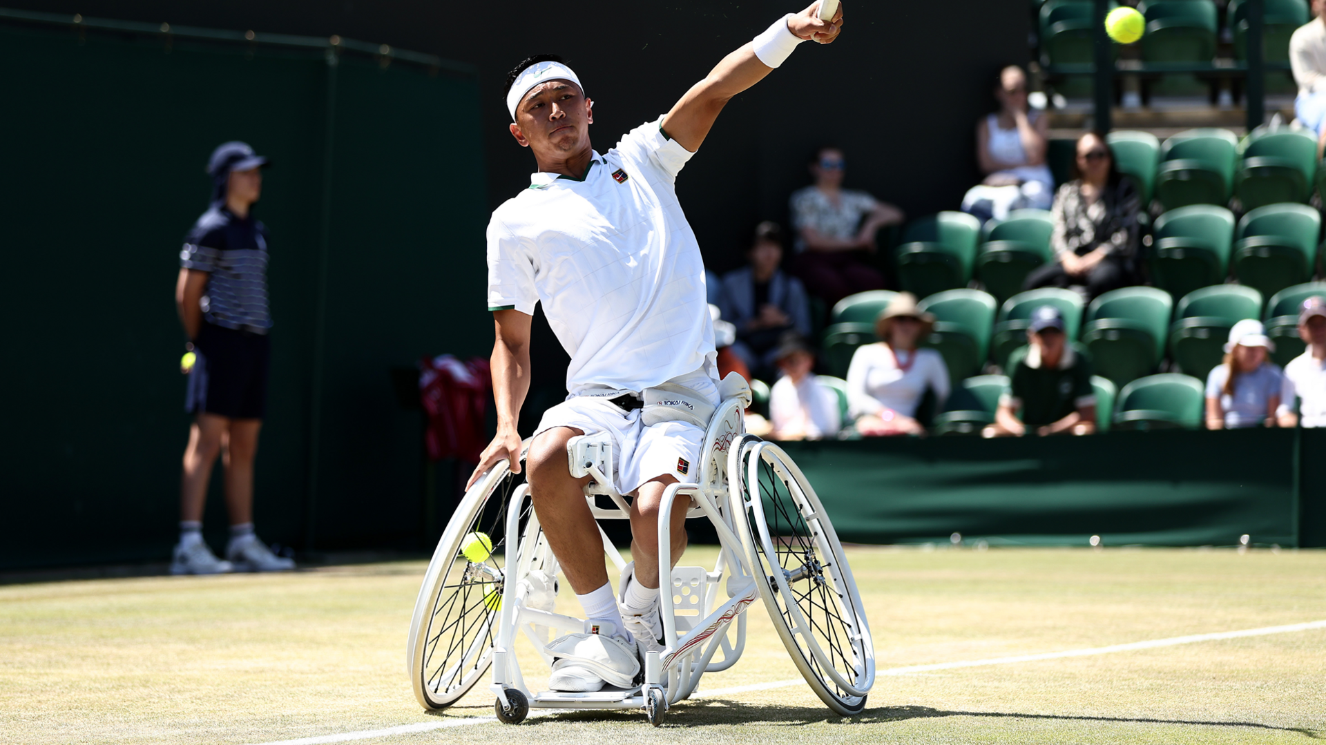 Tokito Oda of Japan in a white wheelchair returning a shot