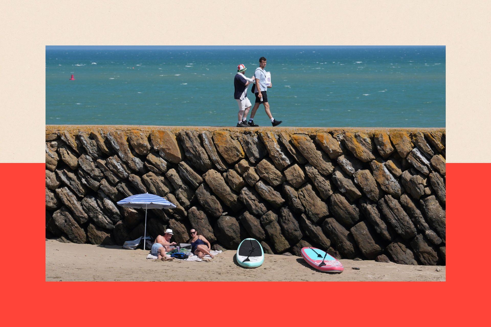 People experiencing the hot weather on Sunny Sands beach in Folkestone, Kent.