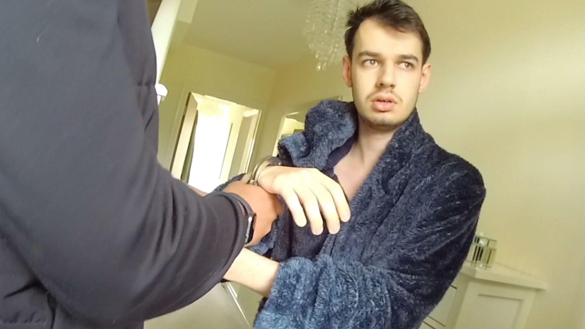Tyler Webb in a dressing gown being arrested by police