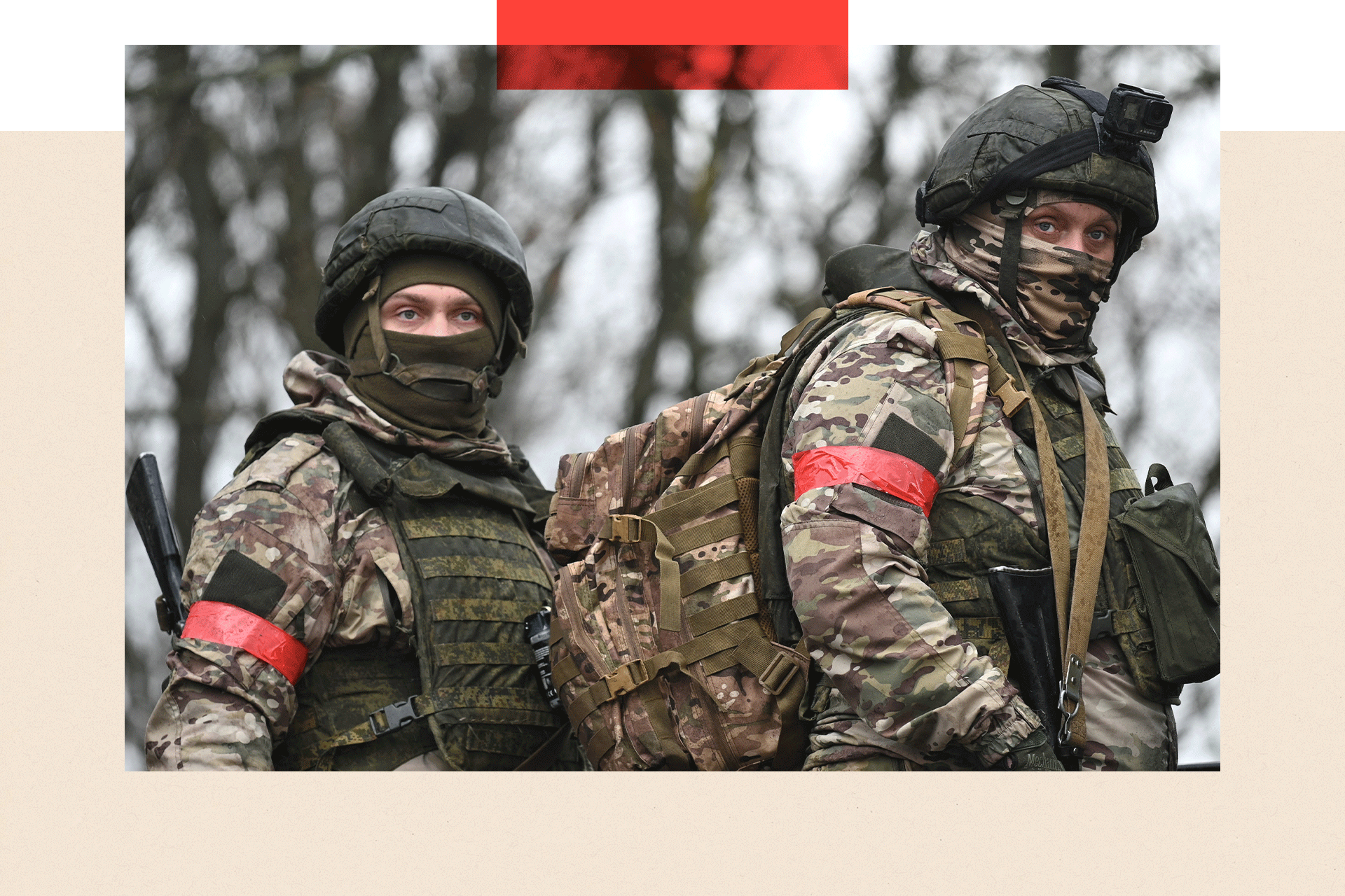 Two soldiers in combat gear carrying lots of equipment 