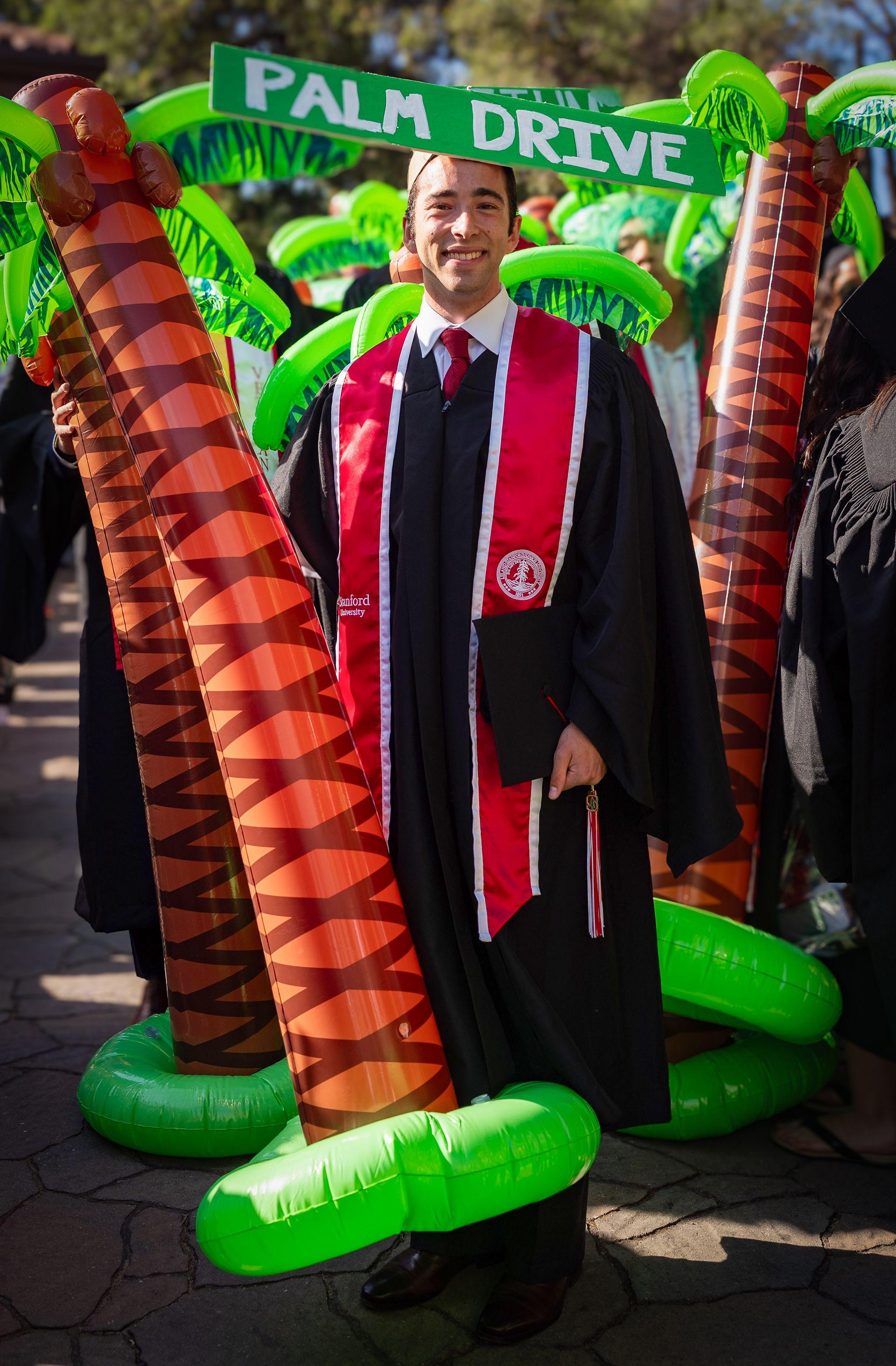 Harry Kaplan with his inflatable palm tree and a sign on his head that says PALM DRIVE
