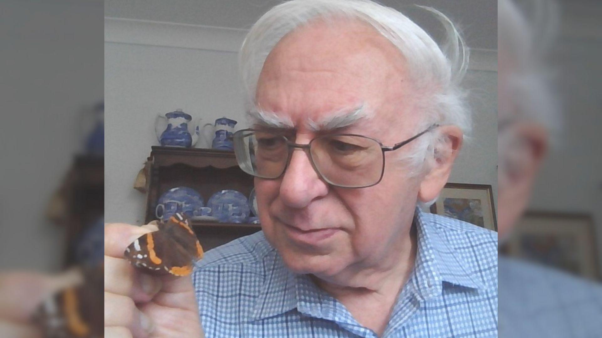 Dr Chris Terrell-Nield with a butterfly on his fingers.