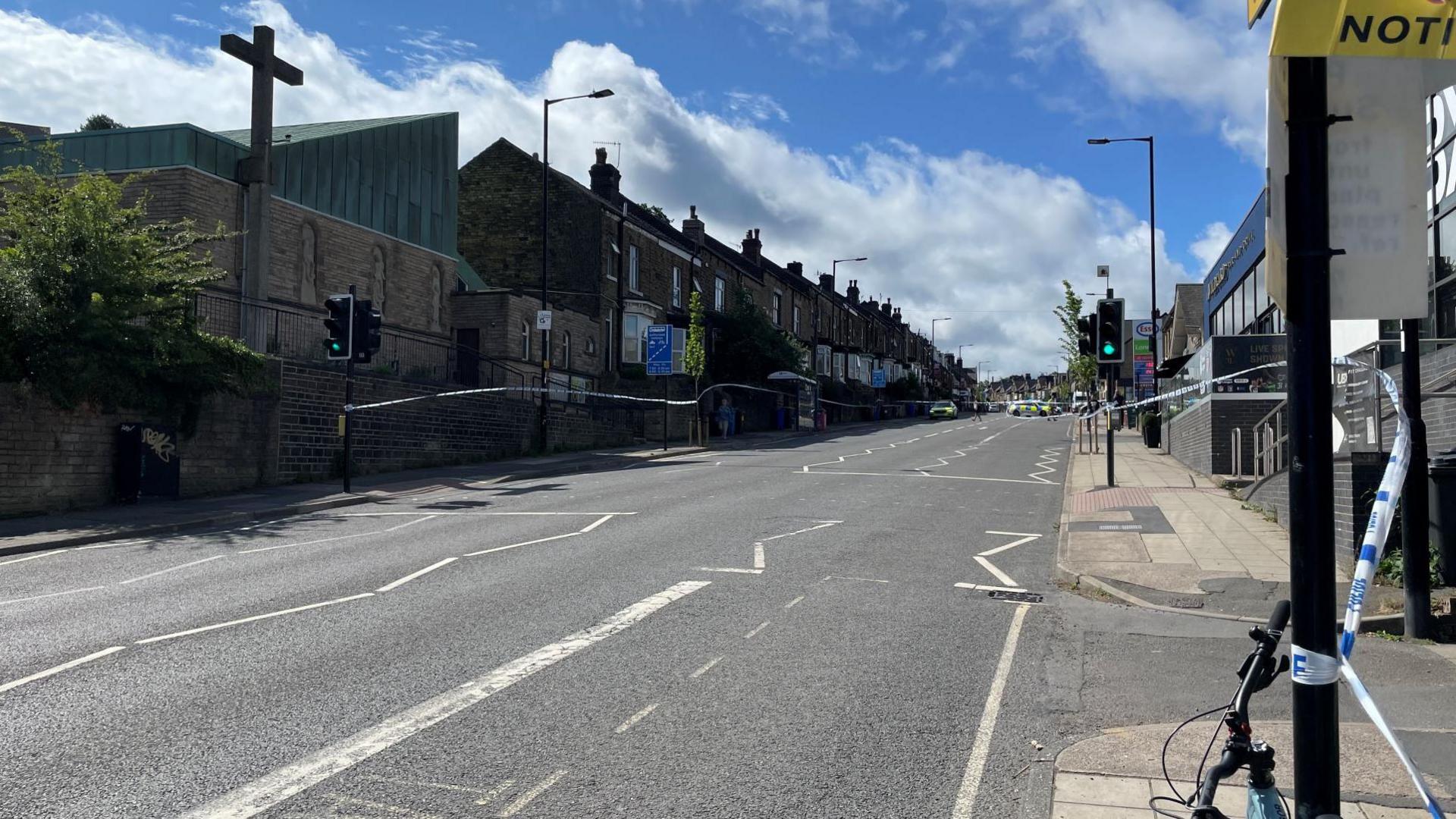 An empty road with a police cordon in place.