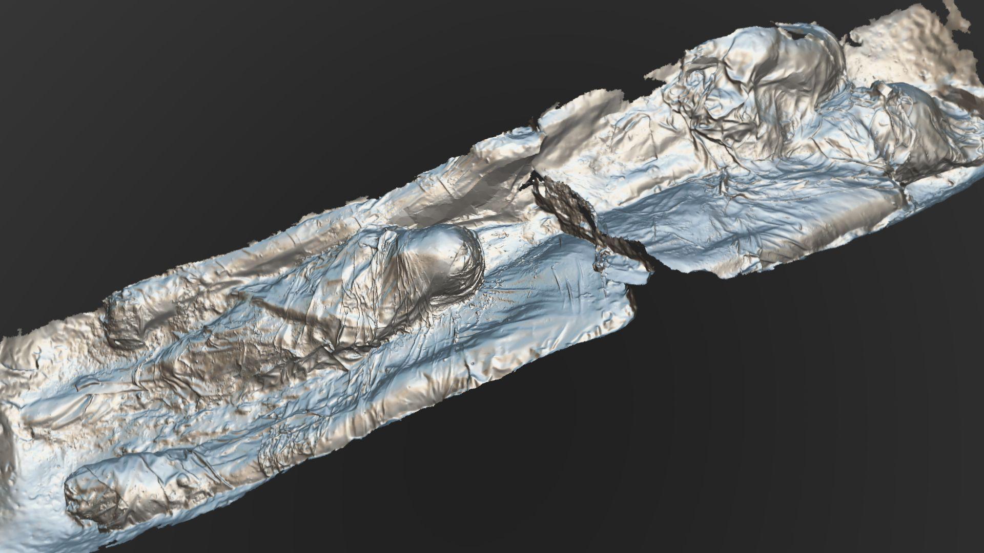 3D-scan of a group of two adults and a child wrapped in shrouds from a gypsum burial in a stone coffin in York.