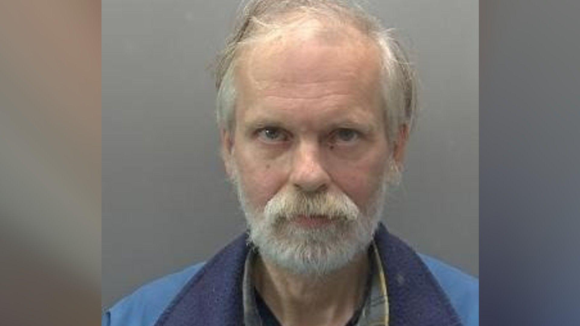 Close-up image of Colin Thackery wearing a jacket with a light blue jacket with a dark blue collar.