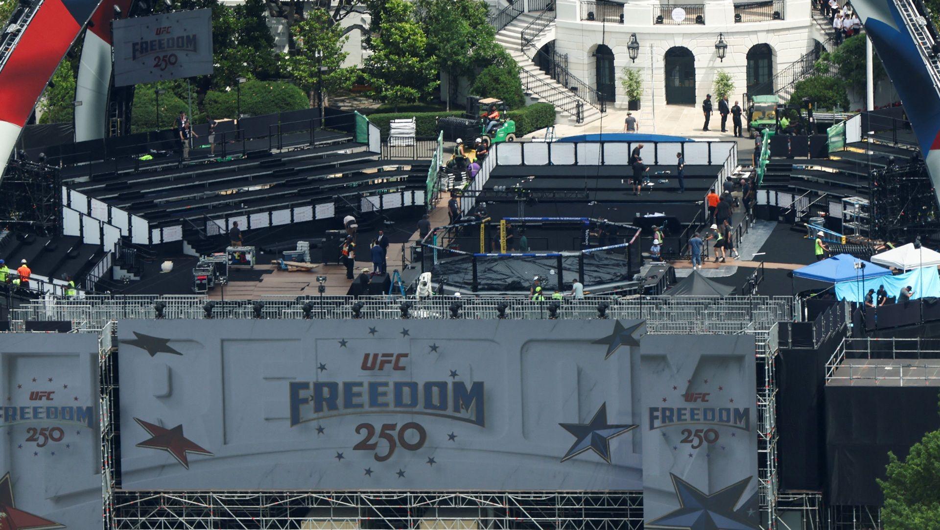 Temporary stands are assembled around a UFC octagon on the South Lawn of the White House