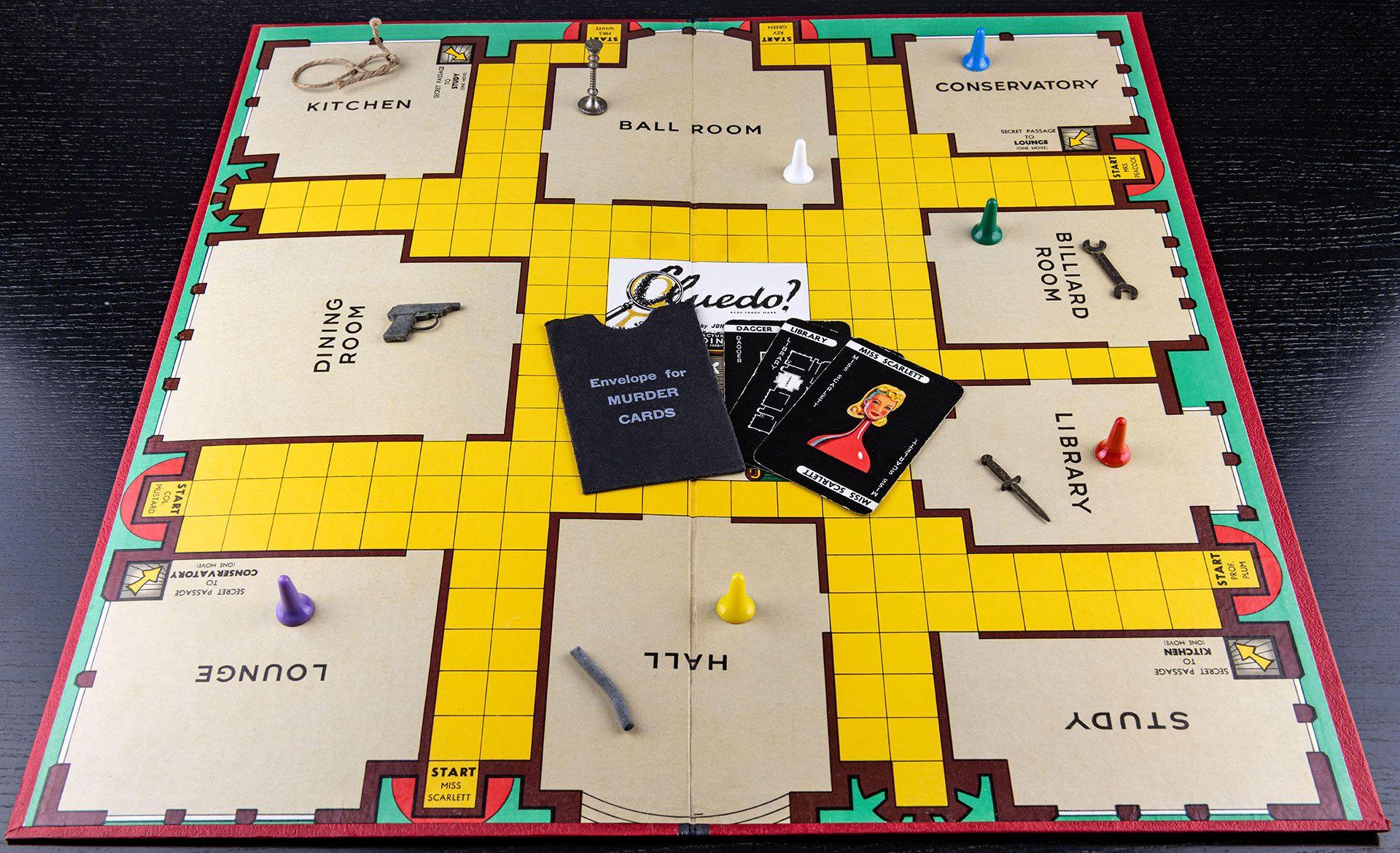 The game Cluedo set up with counters and cards spread on the board.