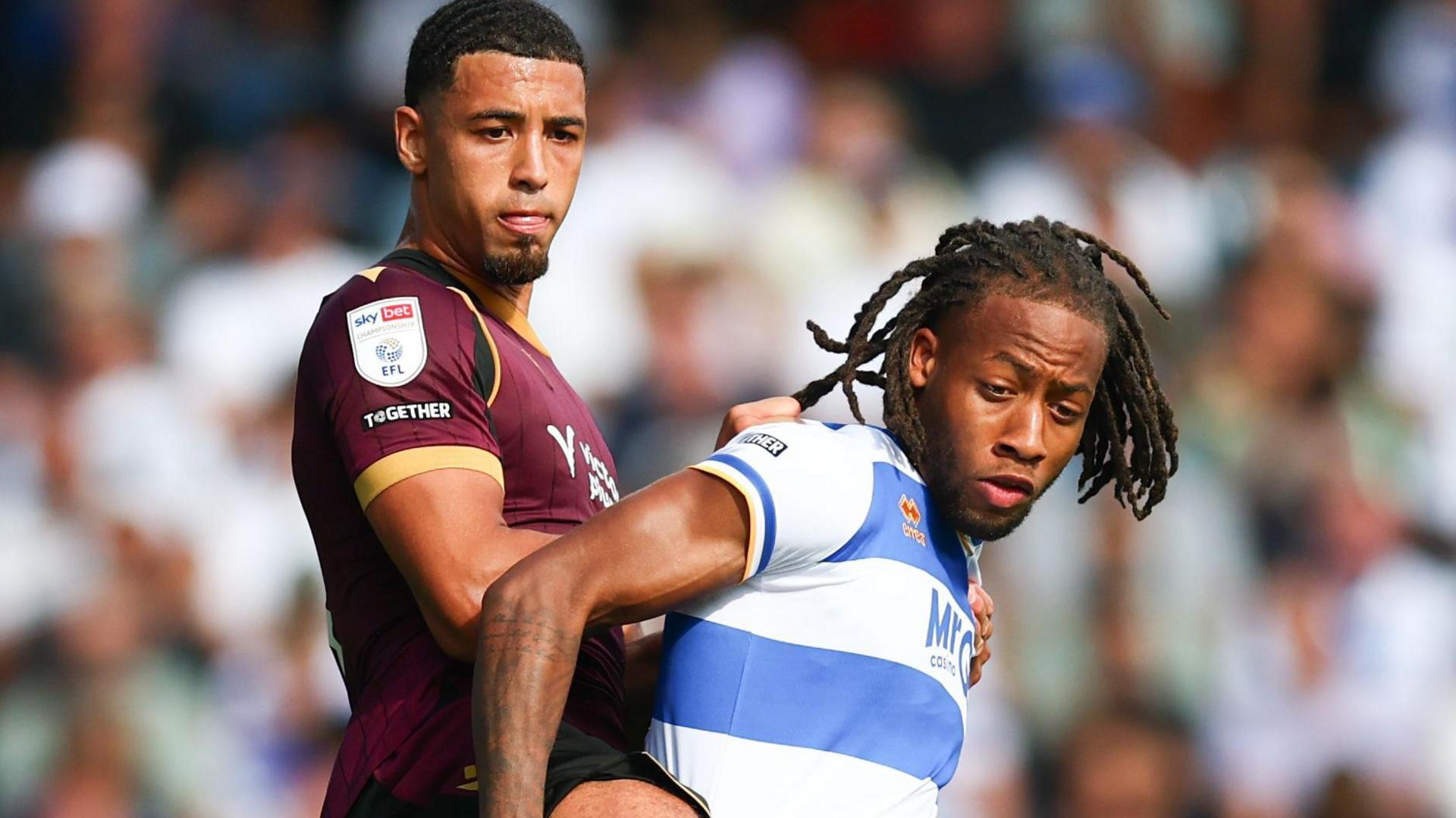 Chris Forino-Joseph of Bolton Wanderers and Rumarn Burrell of Queens Park Rangers battle for the ball