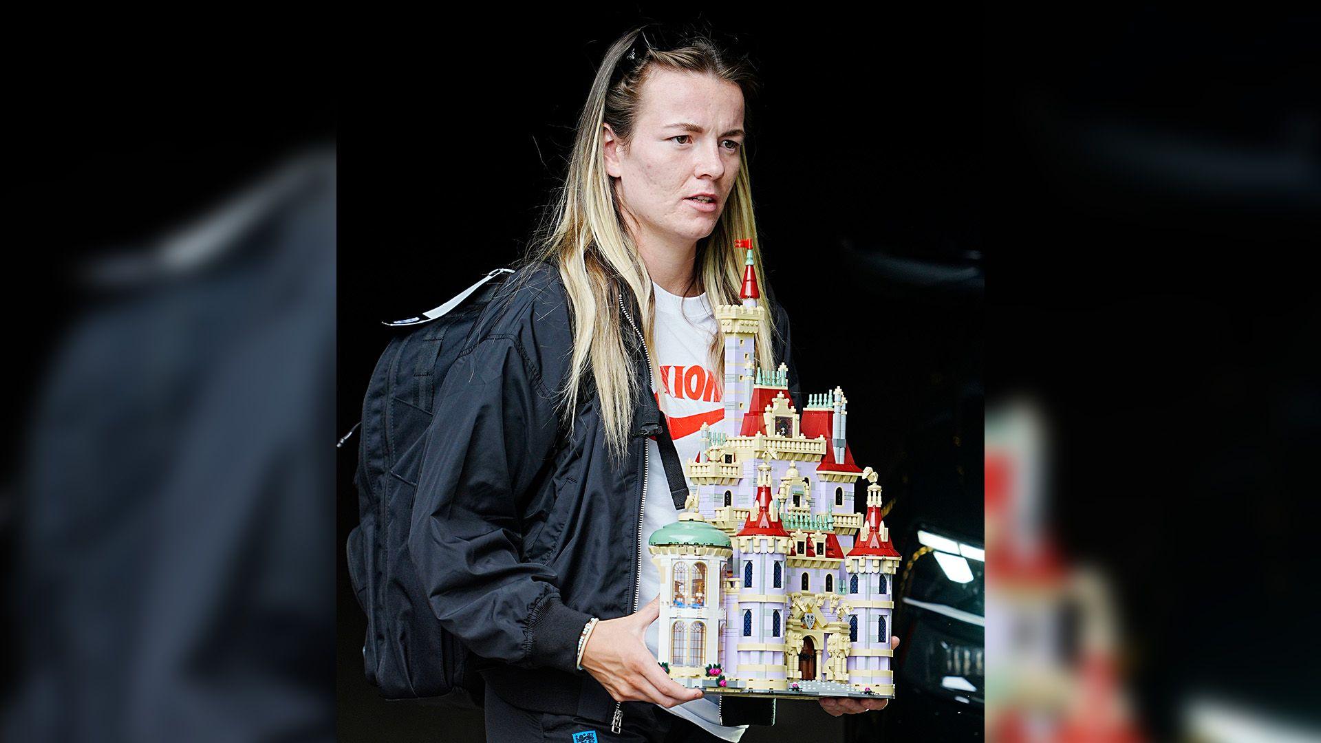 Lauren Hemp carries a lego Beauty and the Beast castle