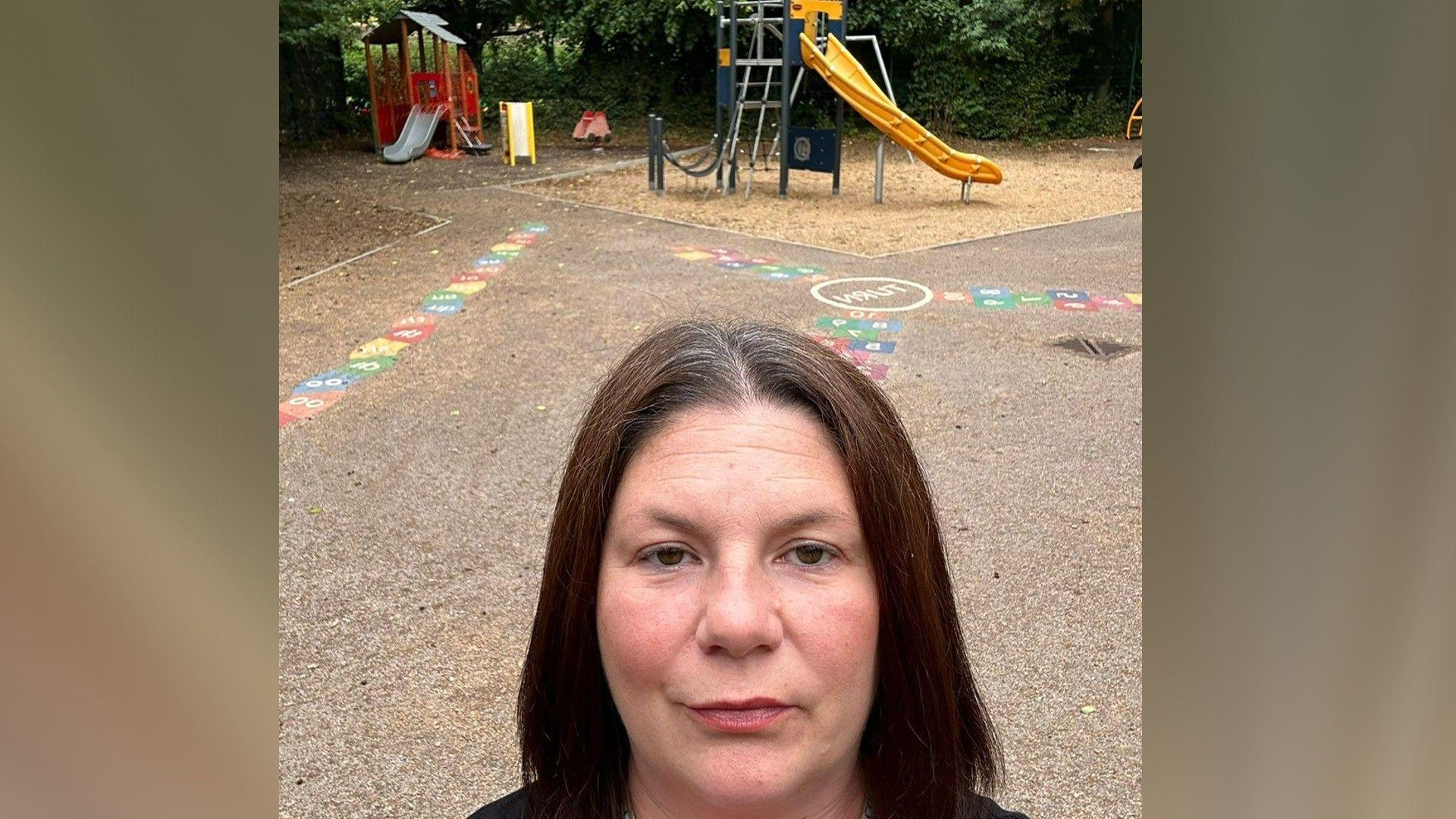 A selfie of Kirsty Knight in front of the play equipment in the park 