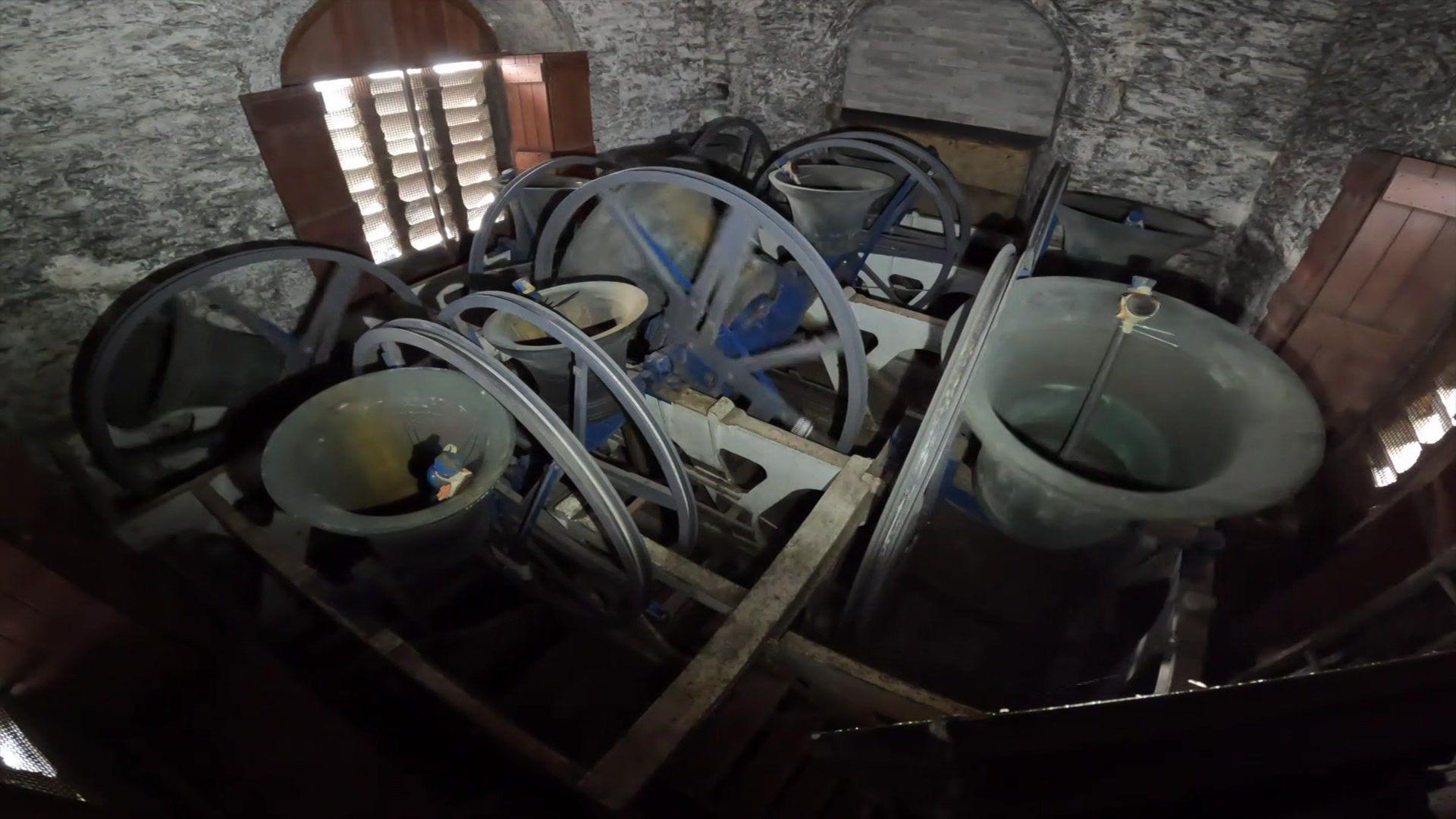 A group of bells at the top of the church.