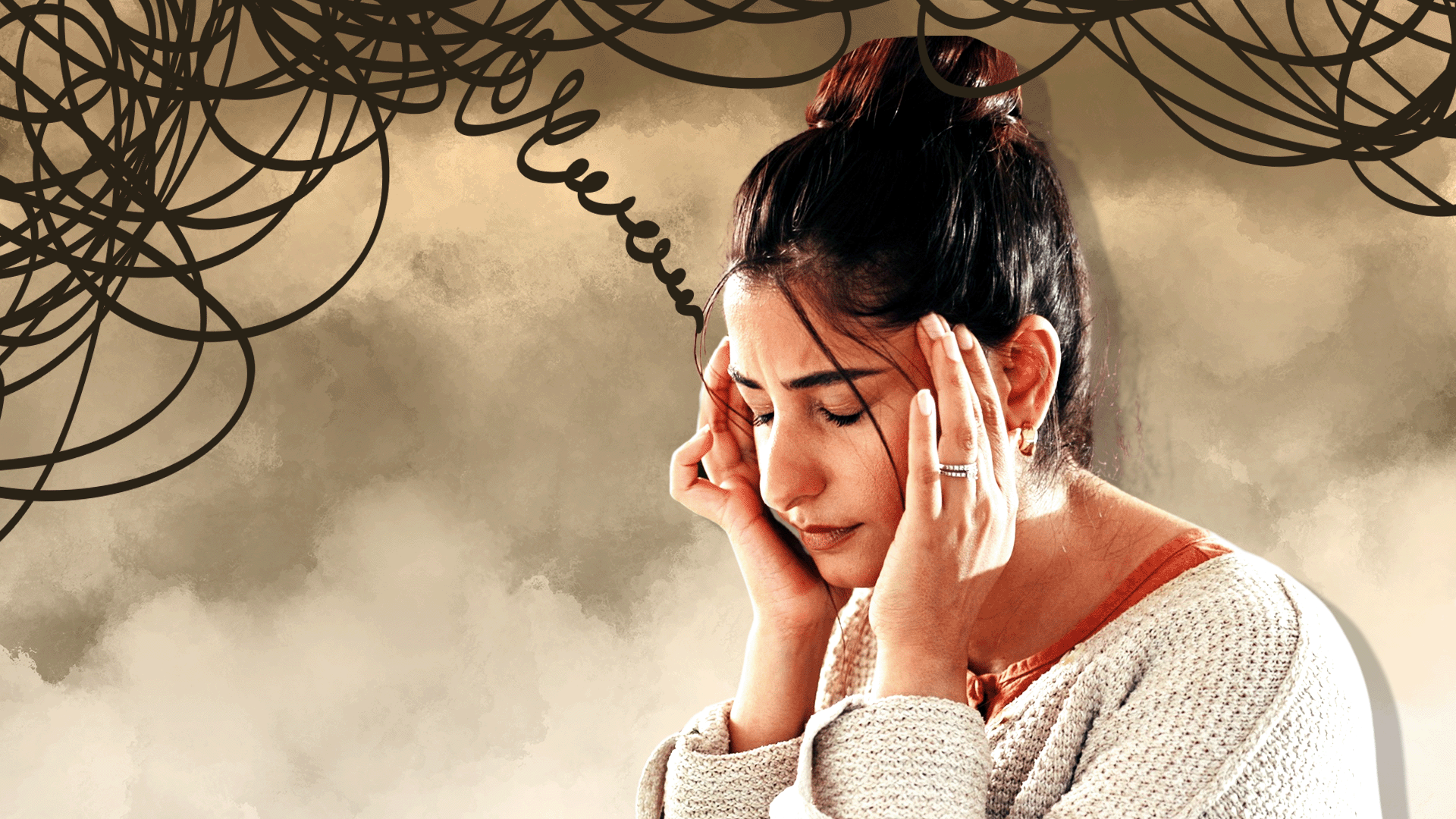 Woman with hands on her head looking stressed
