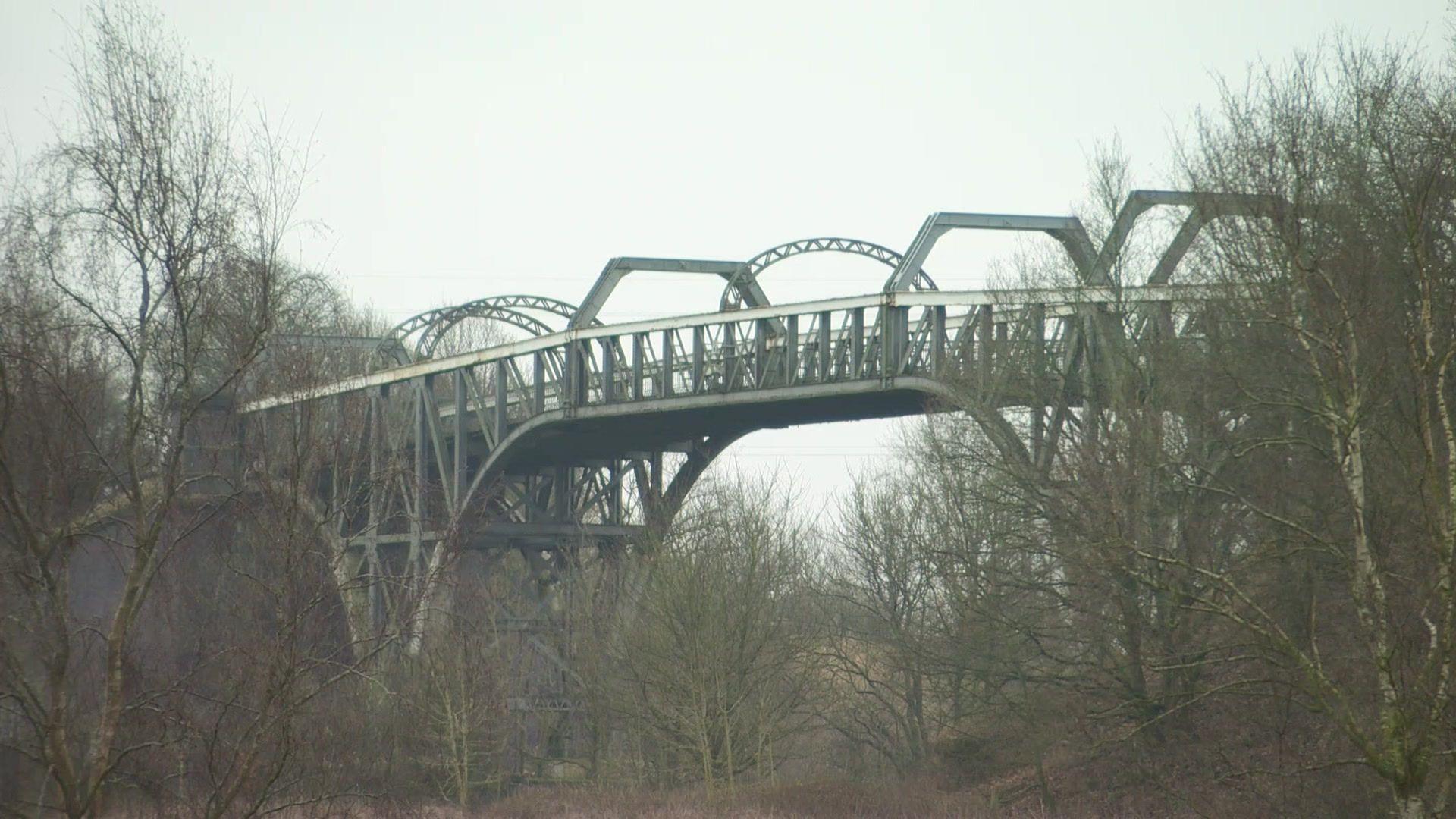 A view of the Warburton toll bridge, which is a steel structure spanning the Manchester Ship Canal. 
