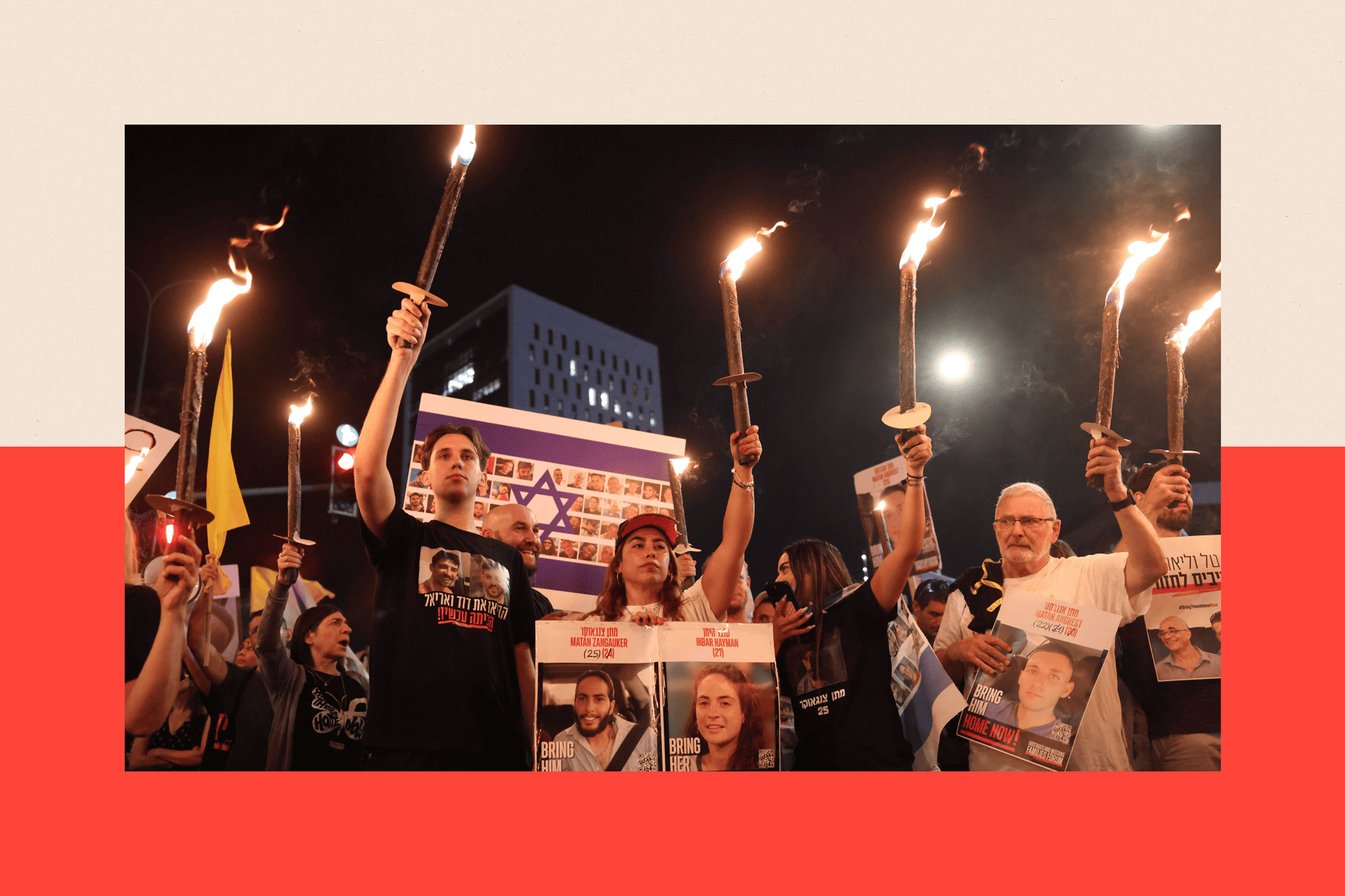 Families and supporters of Israeli hostages held by Hamas in Gaza carrying torches, banners and pictures 
